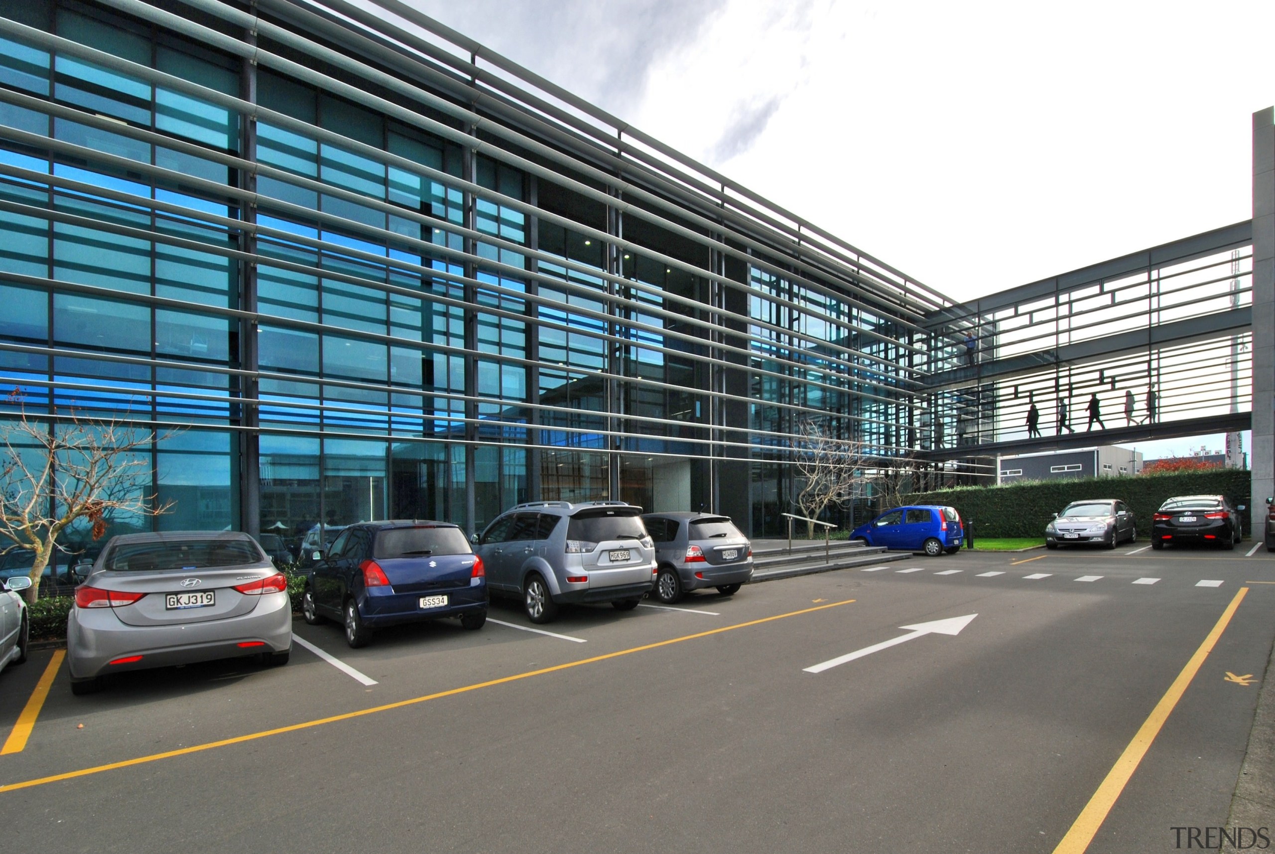 Exterior 2 - airport terminal | building | airport terminal, building, car, city, corporate headquarters, family car, infrastructure, lane, luxury vehicle, metropolis, metropolitan area, motor vehicle, parking, parking lot, road, sedan, structure, transport, gray