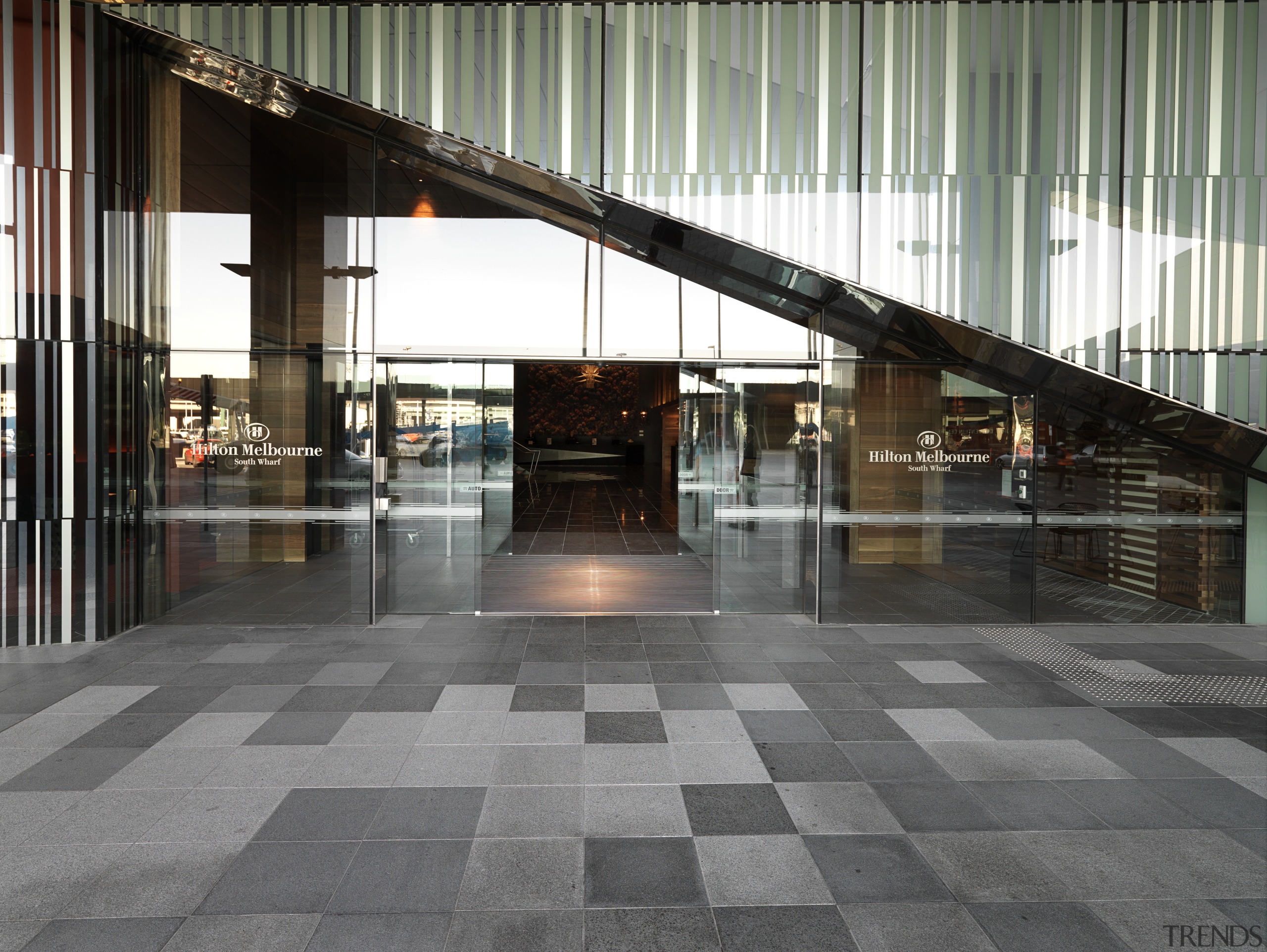 Exterior view of the Hilton Melbouren South Wharf architecture, building, floor, flooring, glass, structure, gray, black