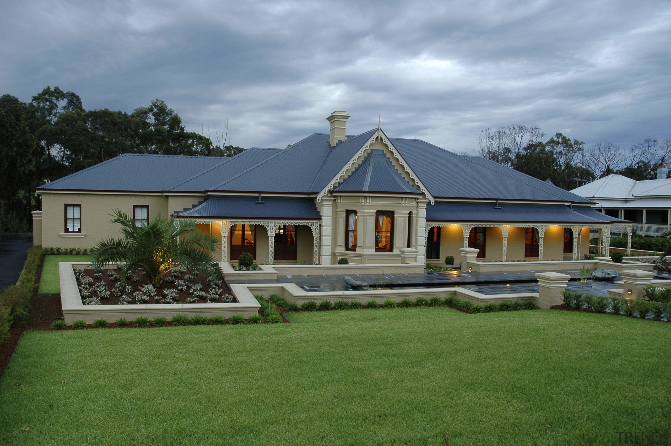 Exterior view of a traditional-styled home designed and cottage, elevation, estate, facade, farmhouse, grass, home, house, landscape, mansion, property, real estate, residential area, roof, villa, window, teal, green