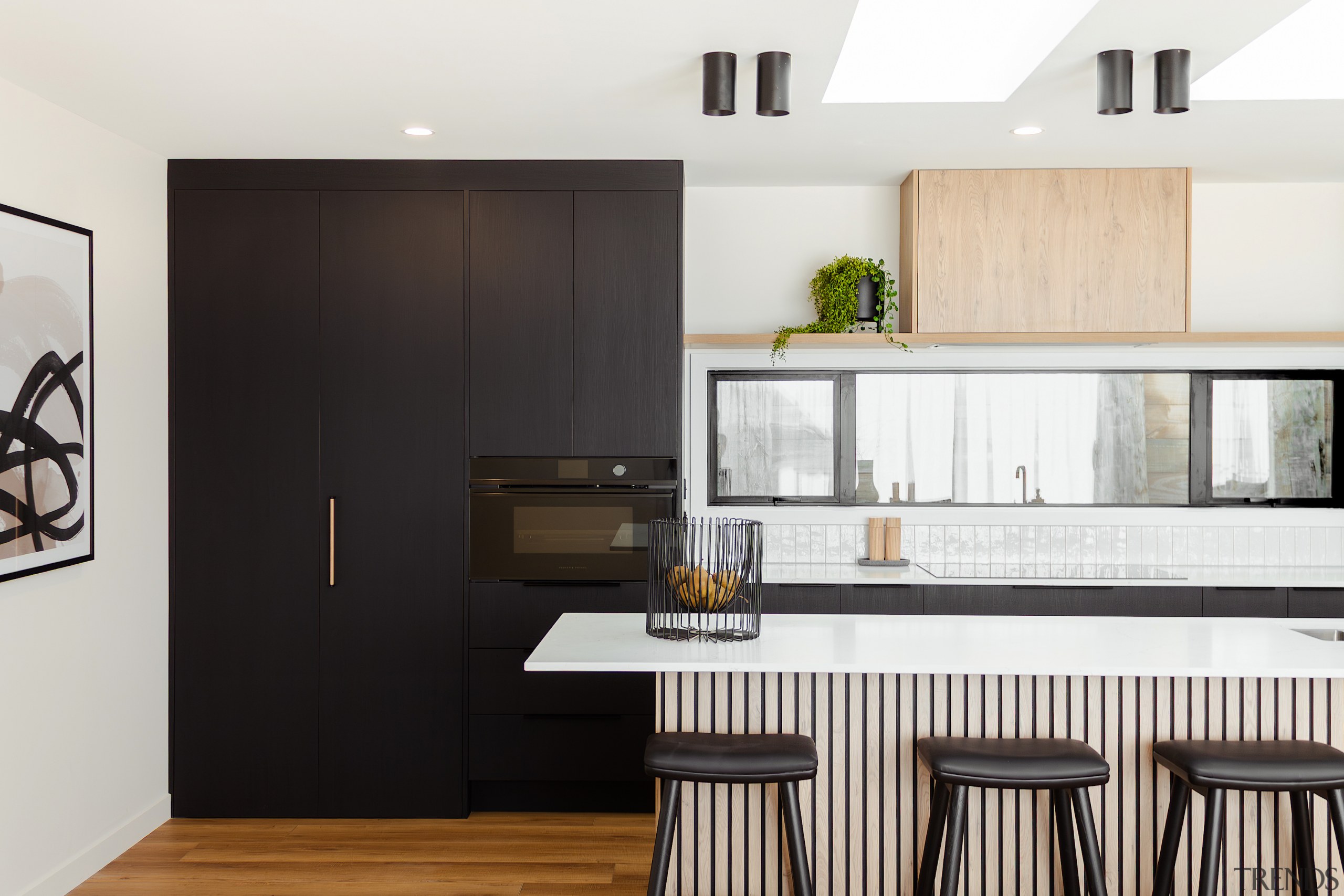 Floating above the window splashback, a natural oak 
