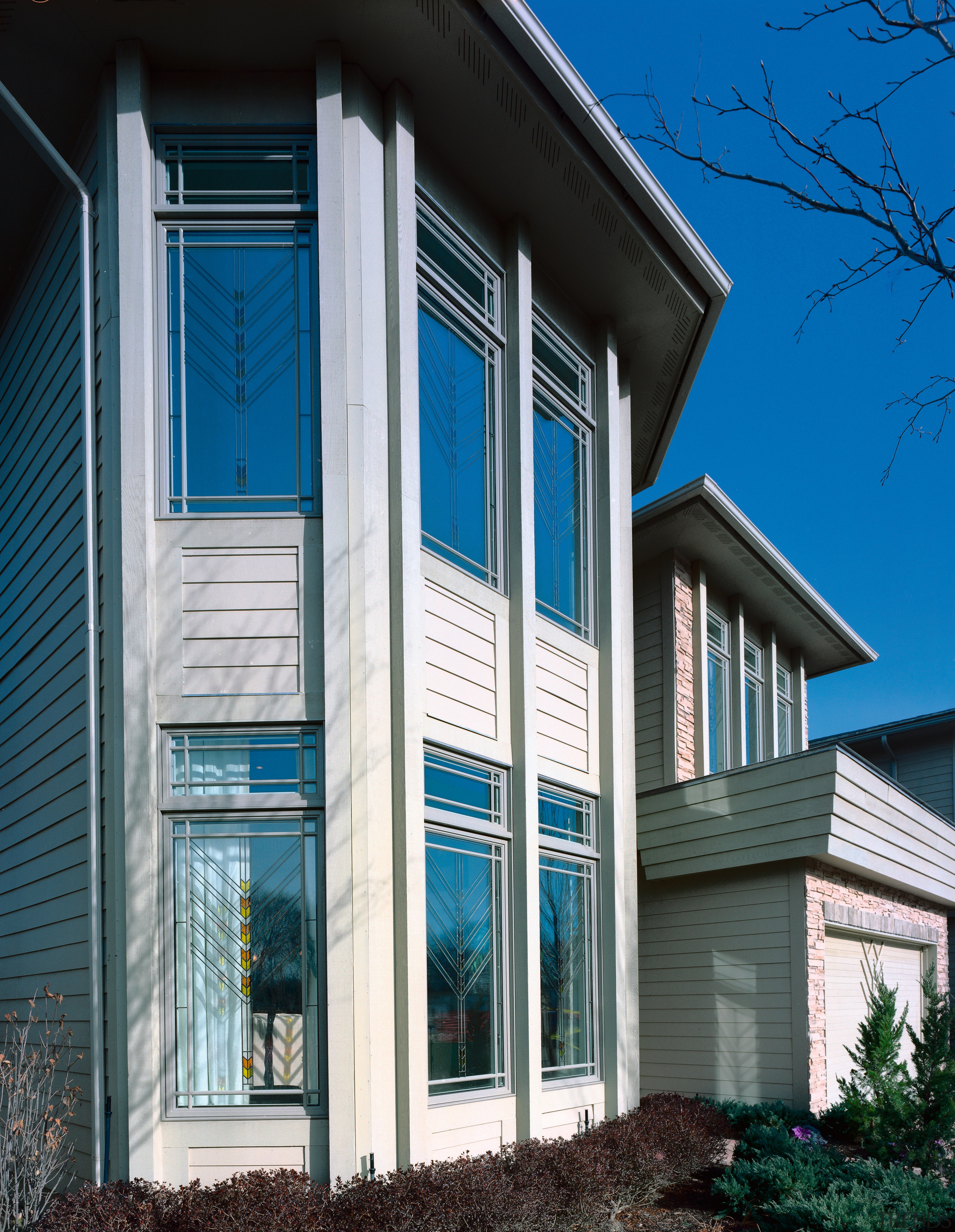 Exterior view of apartment showing patterned glass windows. architecture, building, commercial building, elevation, facade, home, house, property, real estate, residential area, sash window, siding, structure, window, gray, black