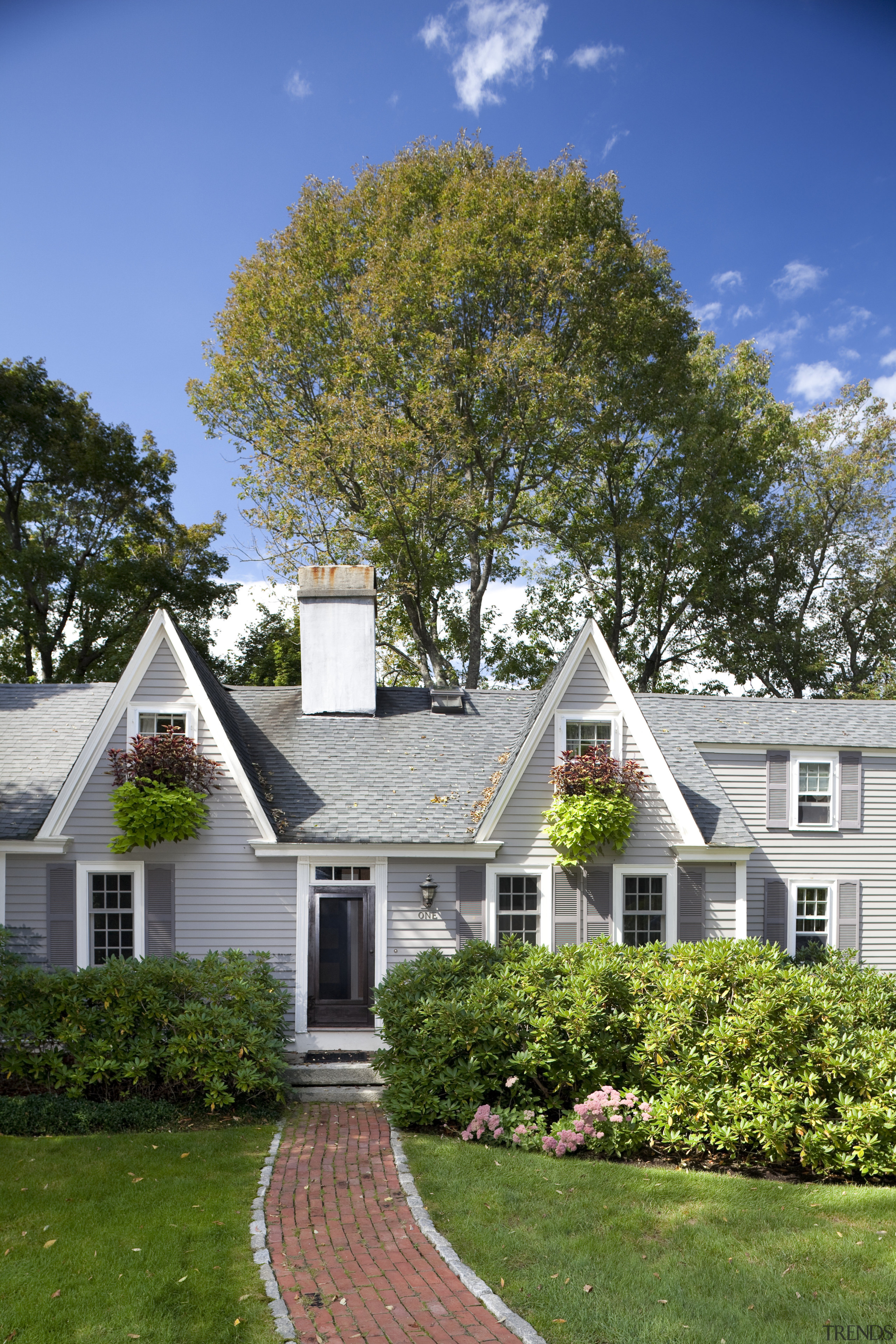 This Cape Cod-style residence was built in 1768, backyard, cottage, estate, facade, farmhouse, grass, historic house, home, house, landscaping, lawn, leaf, mansion, neighbourhood, outdoor structure, plant, plantation, property, real estate, residential area, roof, siding, sky, suburb, tree, yard, brown