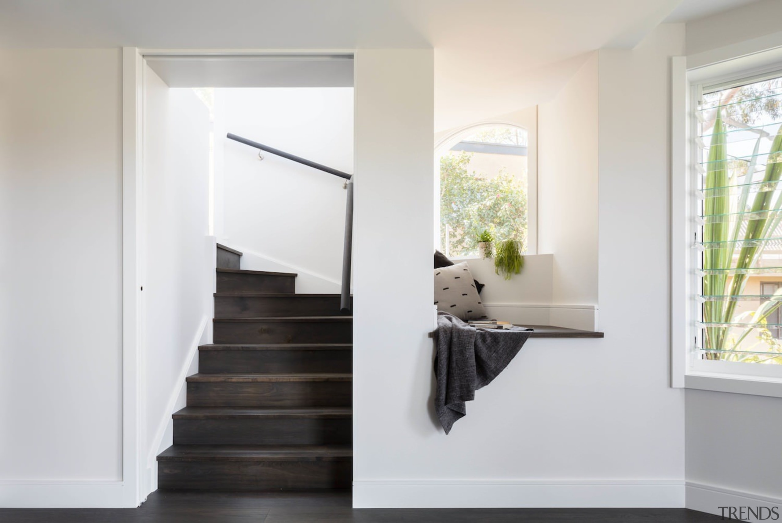 An informal seating area captures the sun - door, floor, home, house, interior design, window, white