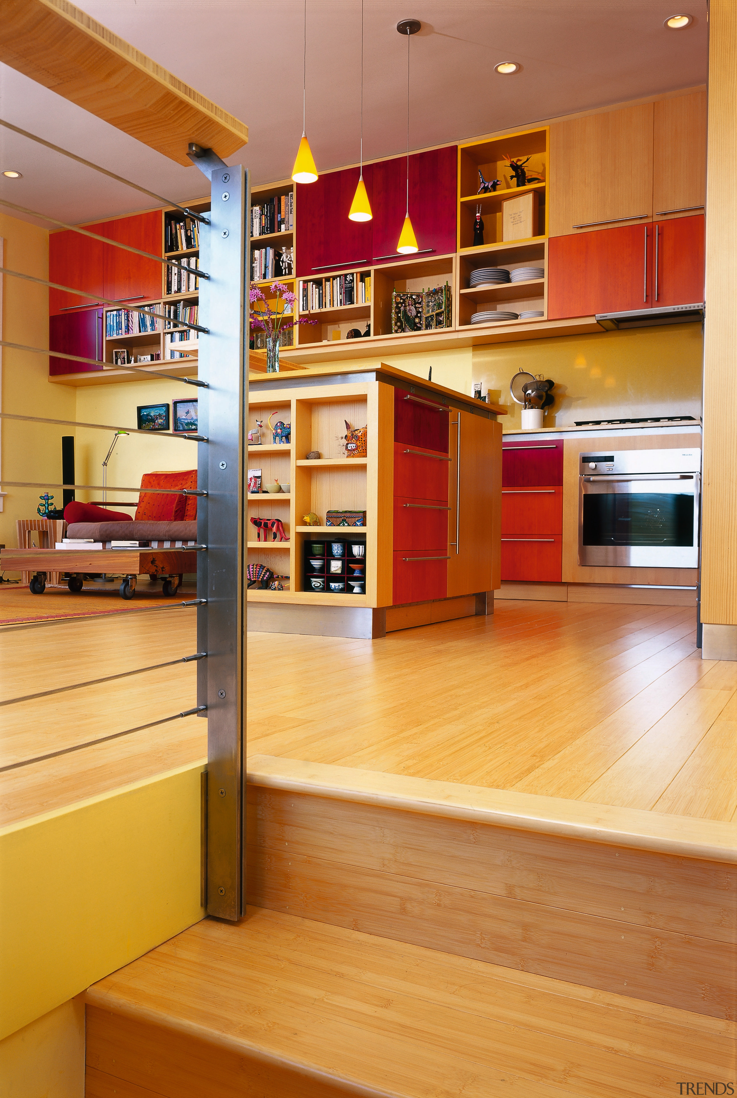 A view of the kitchen area from the bookcase, cabinetry, floor, flooring, furniture, hardwood, interior design, kitchen, shelf, shelving, wood, wood flooring, orange, brown