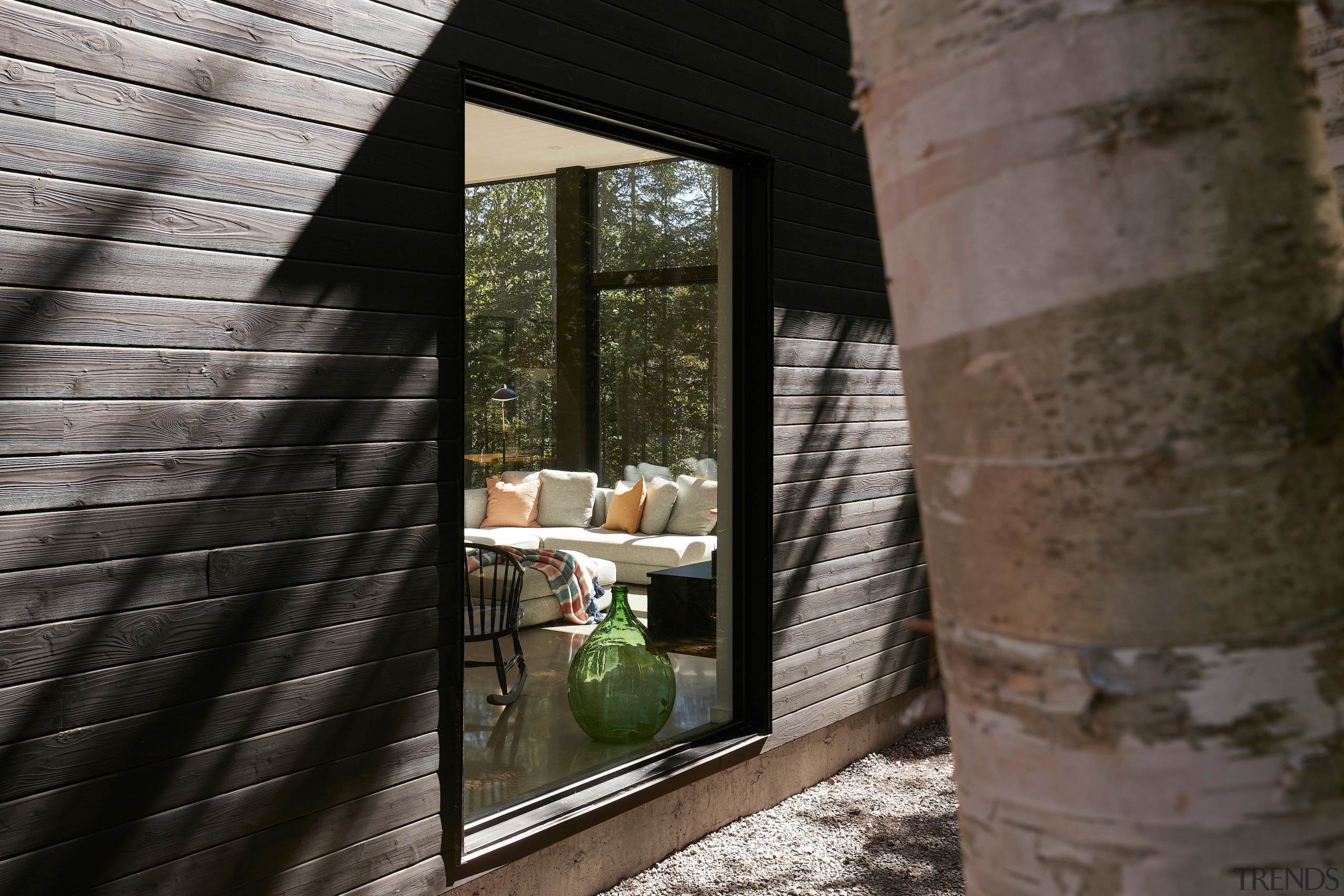 The cottage is clad in  Quebec cedar, burned 