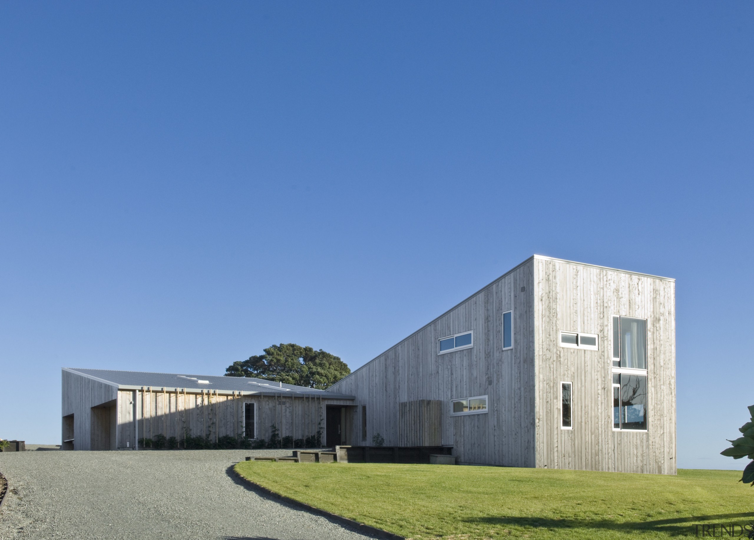 Exterior view of residence which features a monopitched architecture, building, corporate headquarters, facade, farmhouse, home, house, property, real estate, sky, teal
