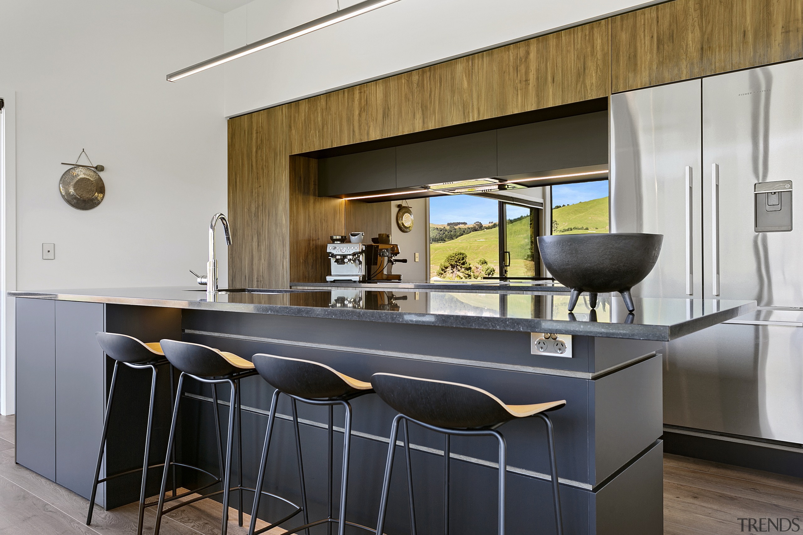 Wood cabinetry tones with the natural golf course 