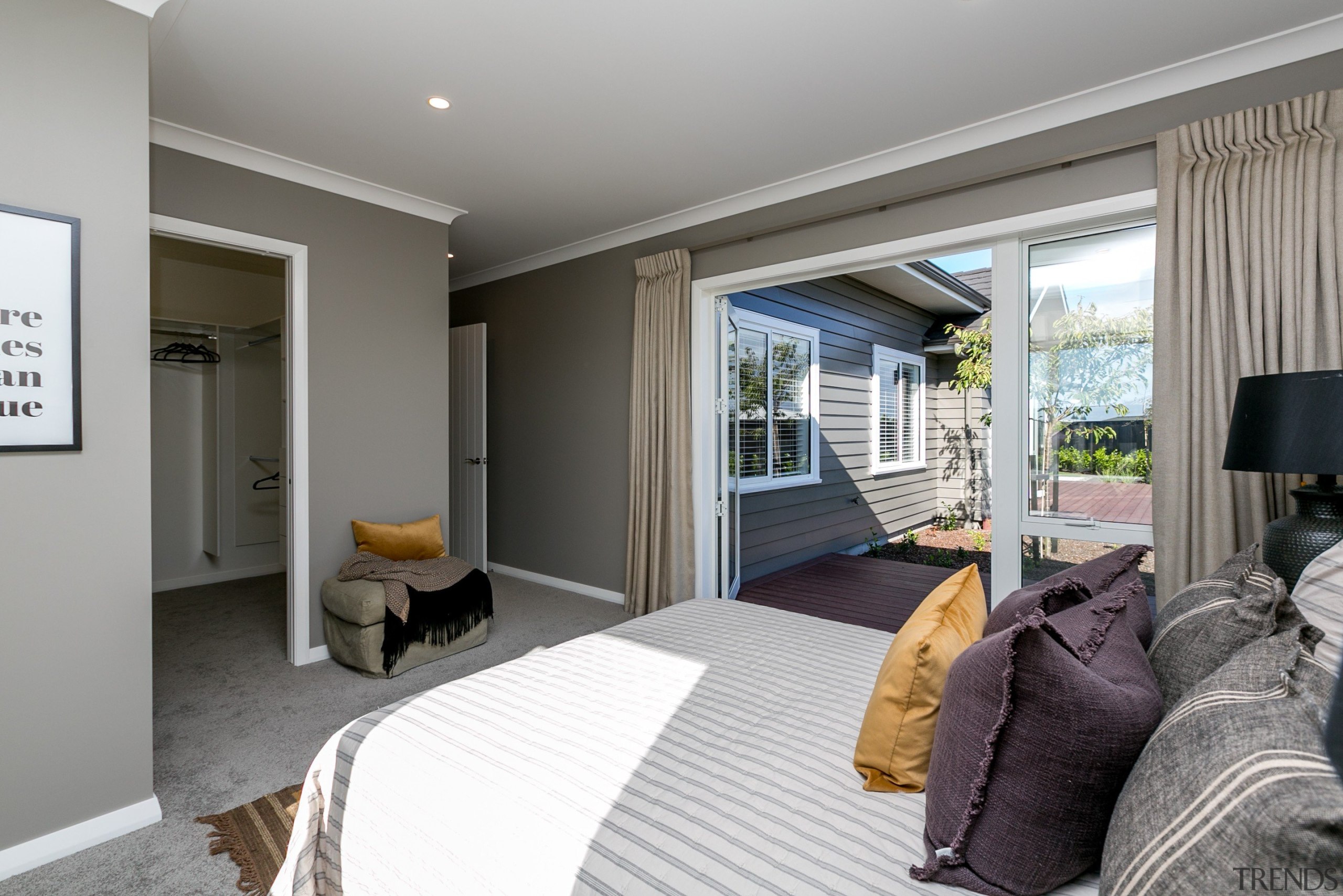 A spacious master suite featuring indoor-outdoor access to bedroom, ceiling, home, interior design, real estate, room, suite, window, gray