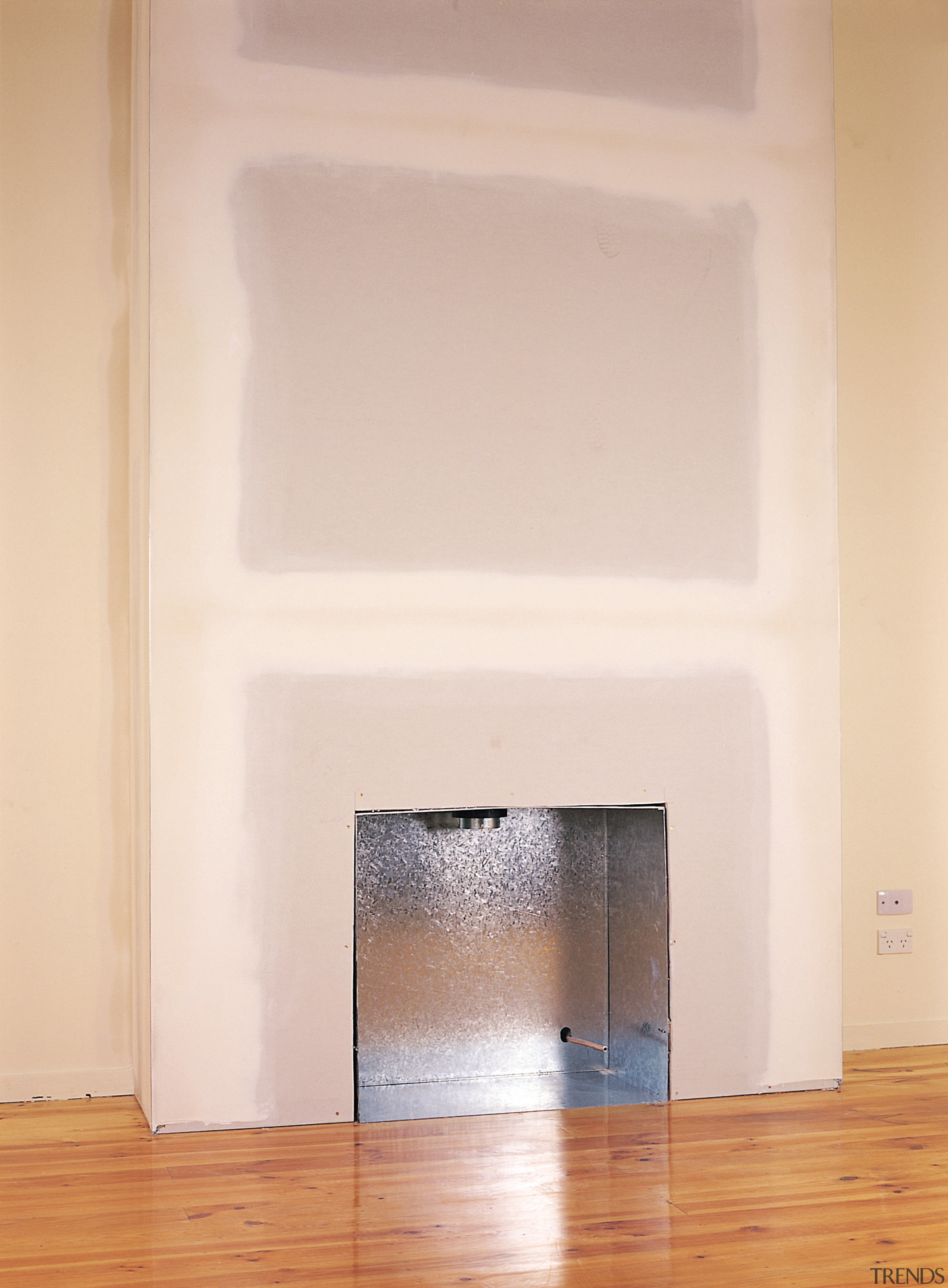 Fire box and mock chimney being installed against fireplace, floor, hardwood, hearth, interior design, plaster, wall, wood, white, orange