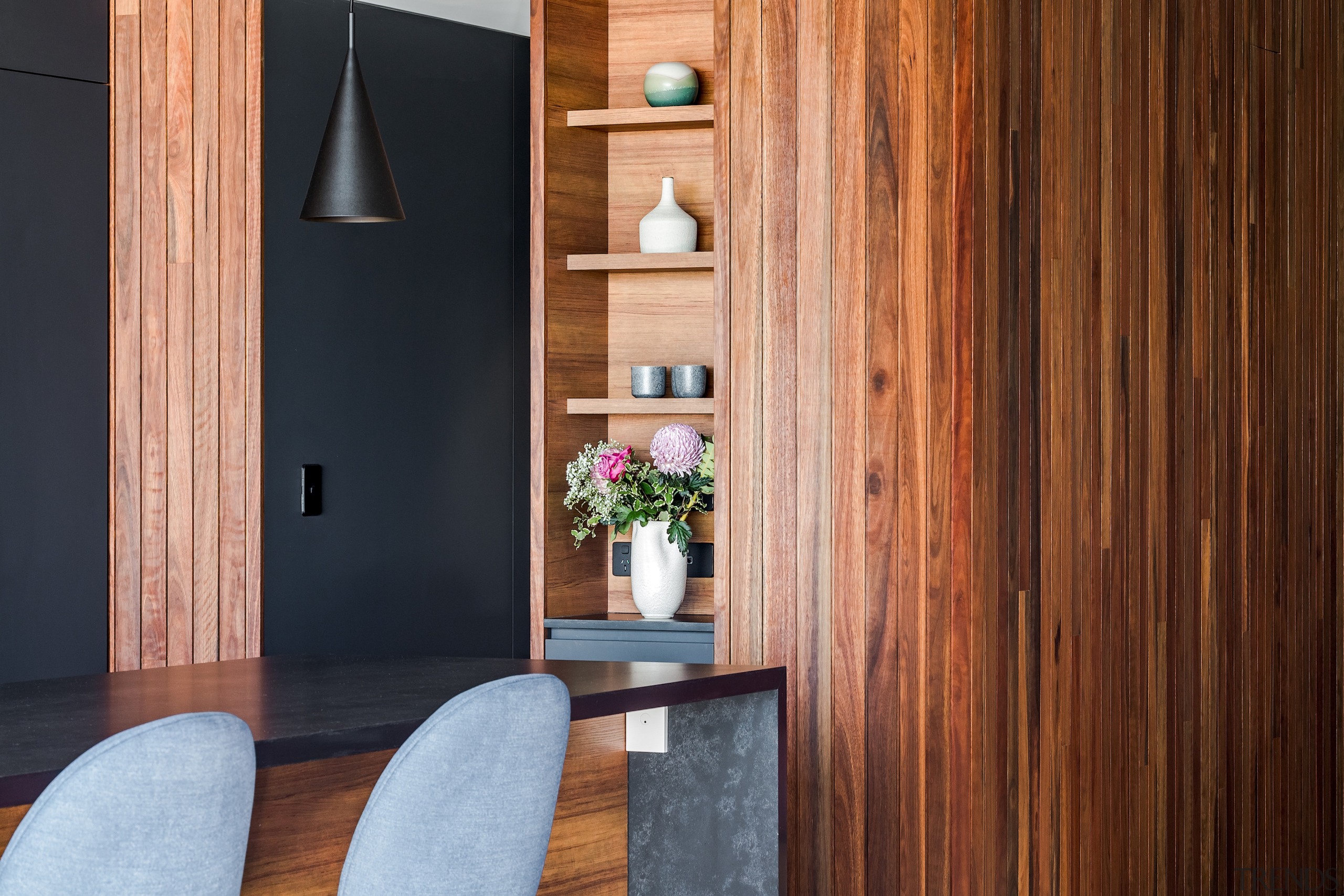 Vertical niche display shelving beside the entry to 