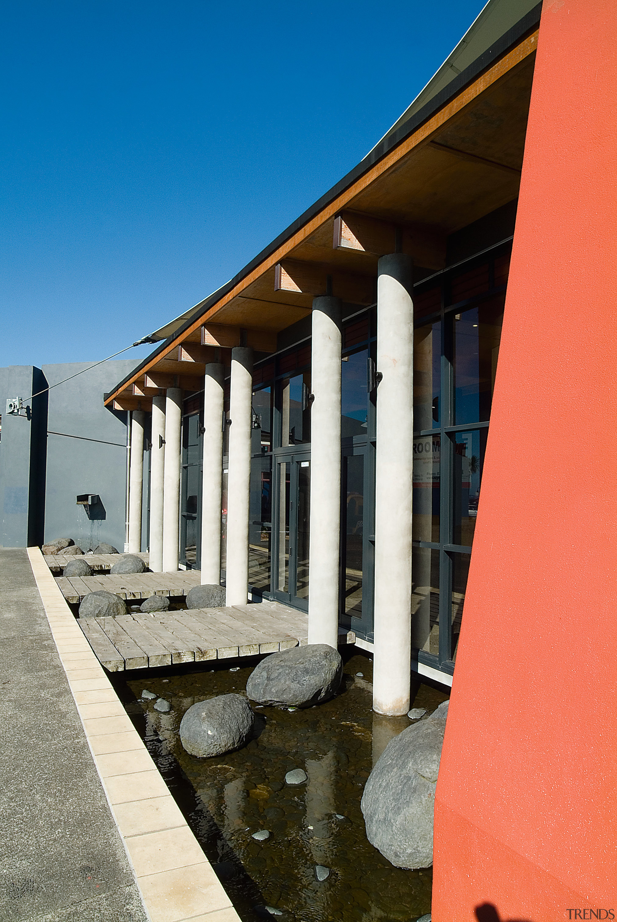 Exterior view of library building with waterway, small architecture, column, sky, structure