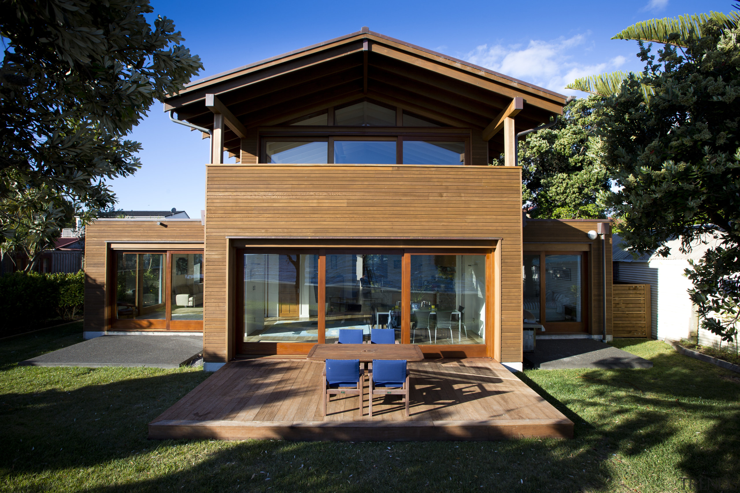 In this seaside house by Novak+Middleton, sliding doors architecture, cottage, elevation, estate, facade, home, house, property, real estate, residential area, siding, villa, window, black