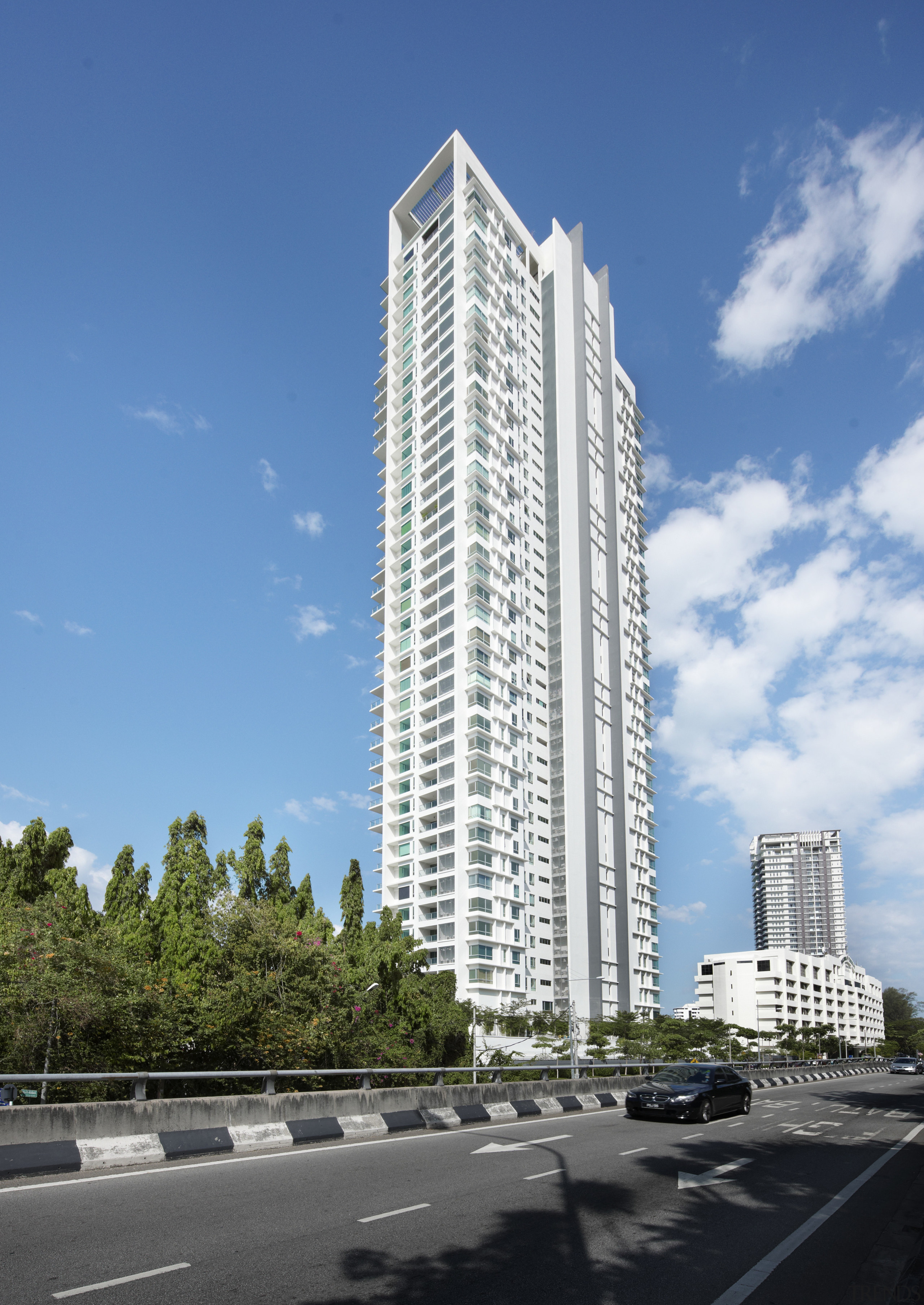 Exterior view of the Springtide Residence on Penang architecture, building, city, commercial building, condominium, corporate headquarters, daytime, facade, headquarters, landmark, metropolis, metropolitan area, mixed use, residential area, sky, skyscraper, tower, tower block, urban area, teal