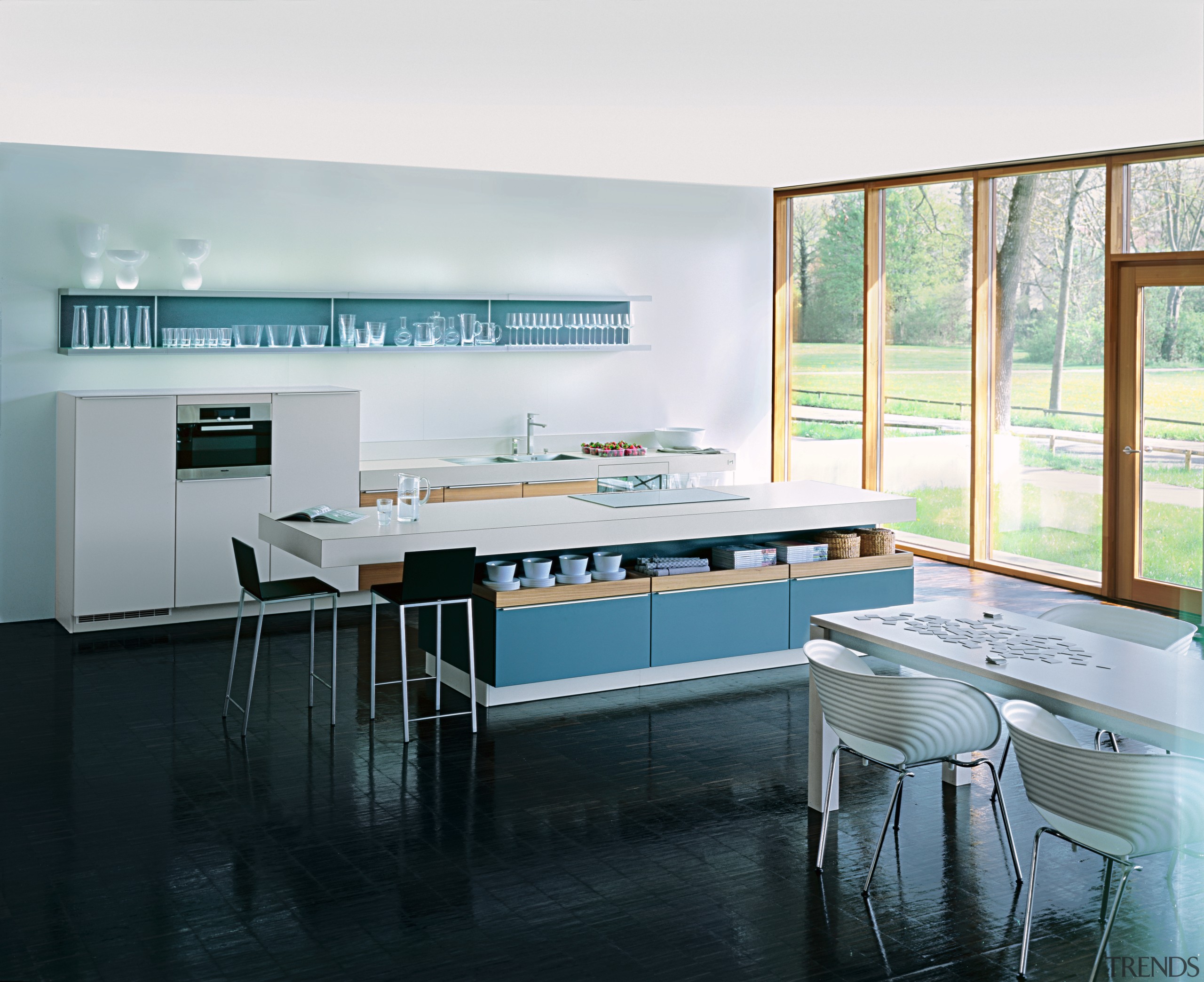 A view of a kitchen by Poggenphol Kitchens. countertop, interior design, kitchen, room, table, window, white, black