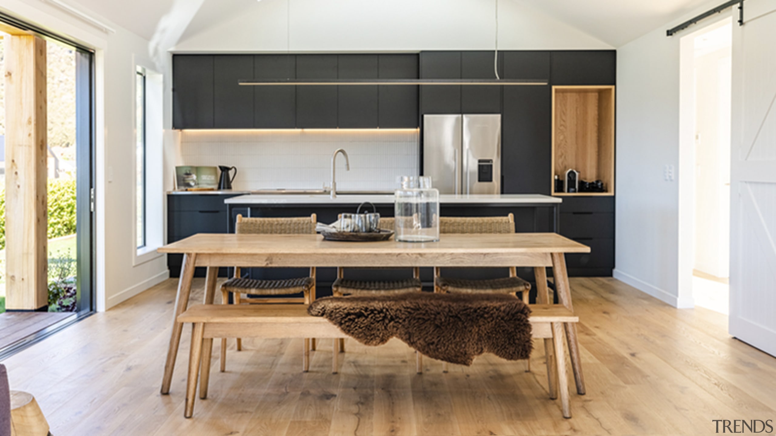 The living/family space's white and wood finishes and 