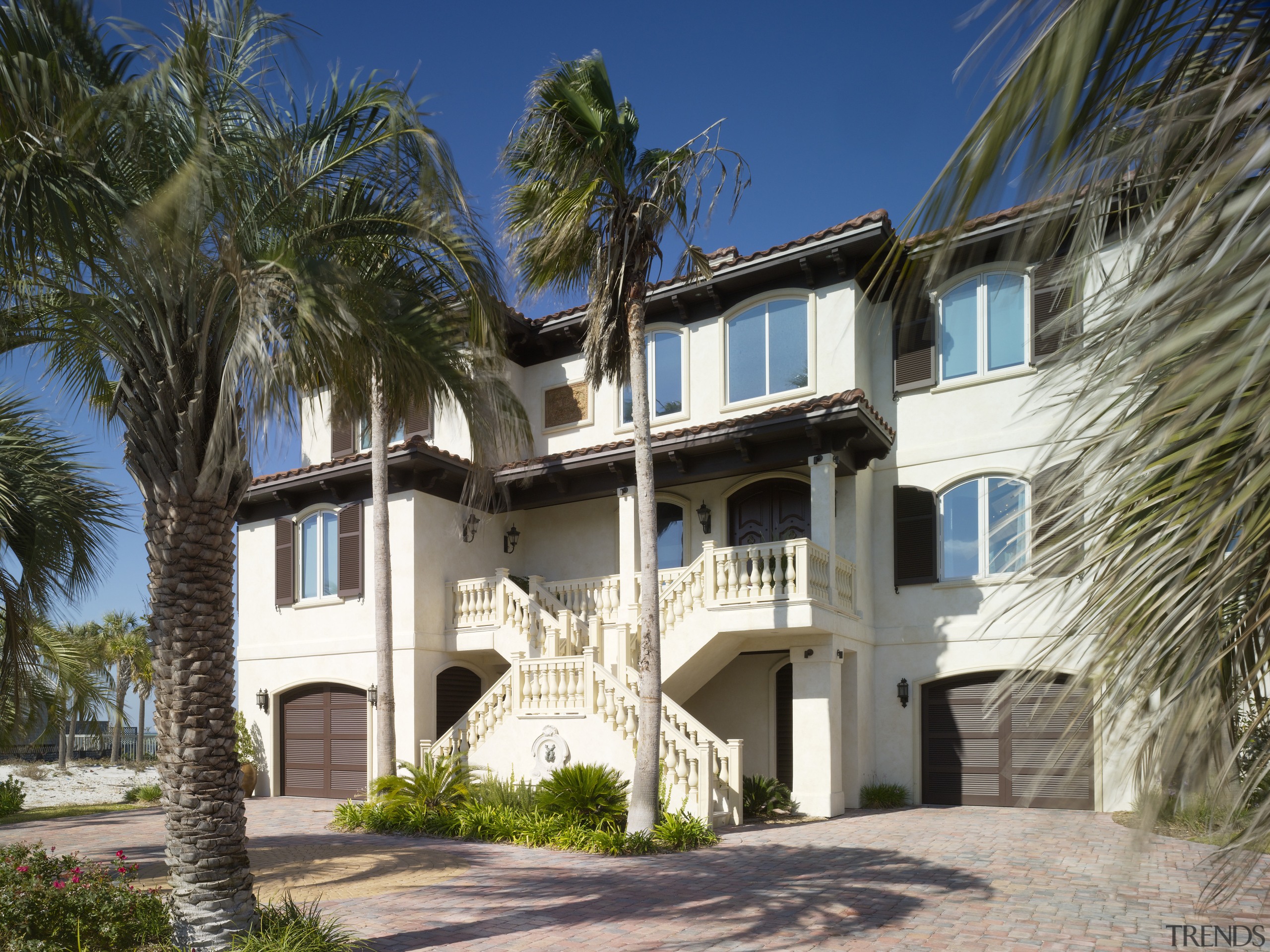 Exterior view of residence which features balconies with apartment, arecales, building, condominium, estate, facade, home, house, mansion, palm tree, property, real estate, residential area, tree, villa, window, brown