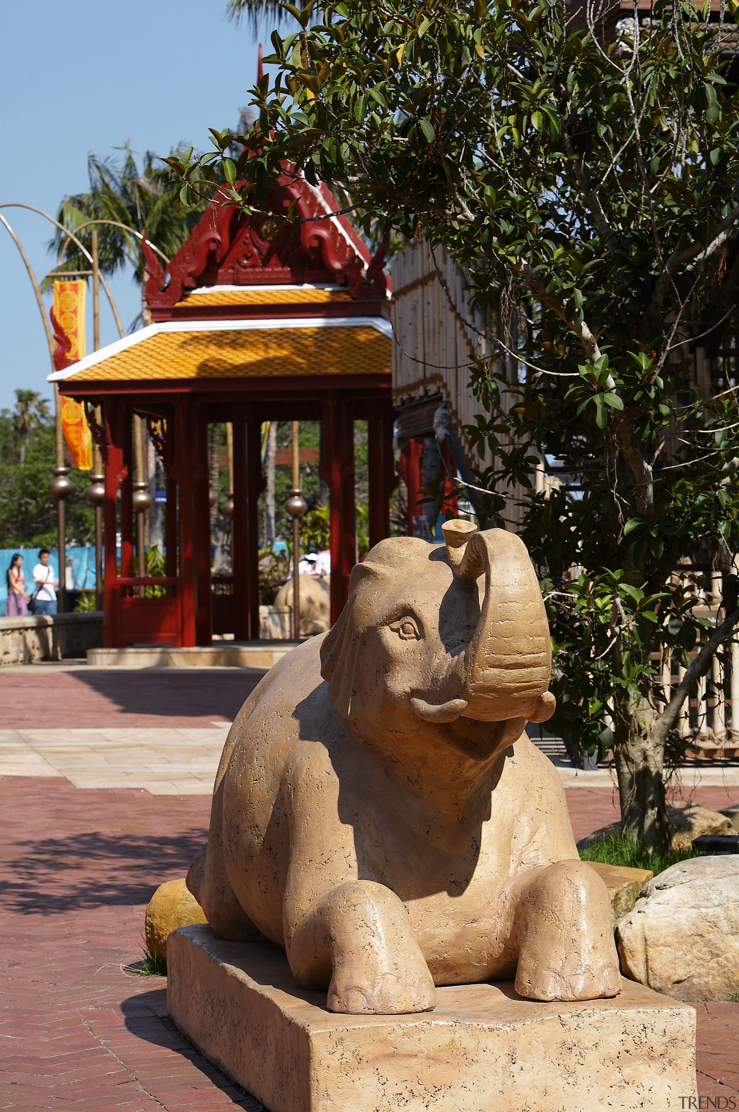 A view of the public outdoor area of carving, monument, sculpture, statue, temple, tree, brown