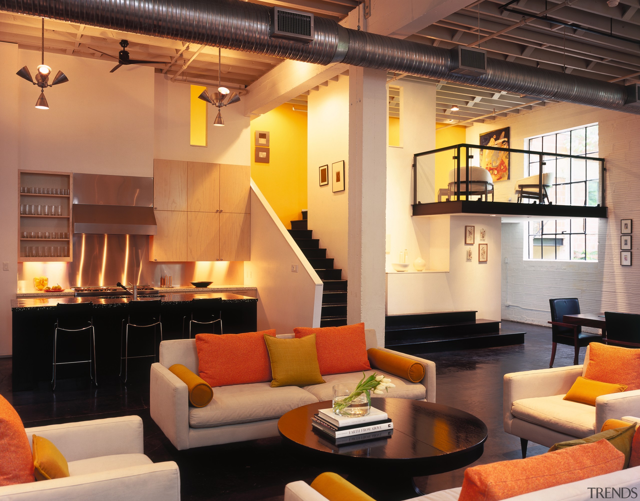 A view of the interior living area featuring ceiling, interior design, living room, loft, room, orange, black