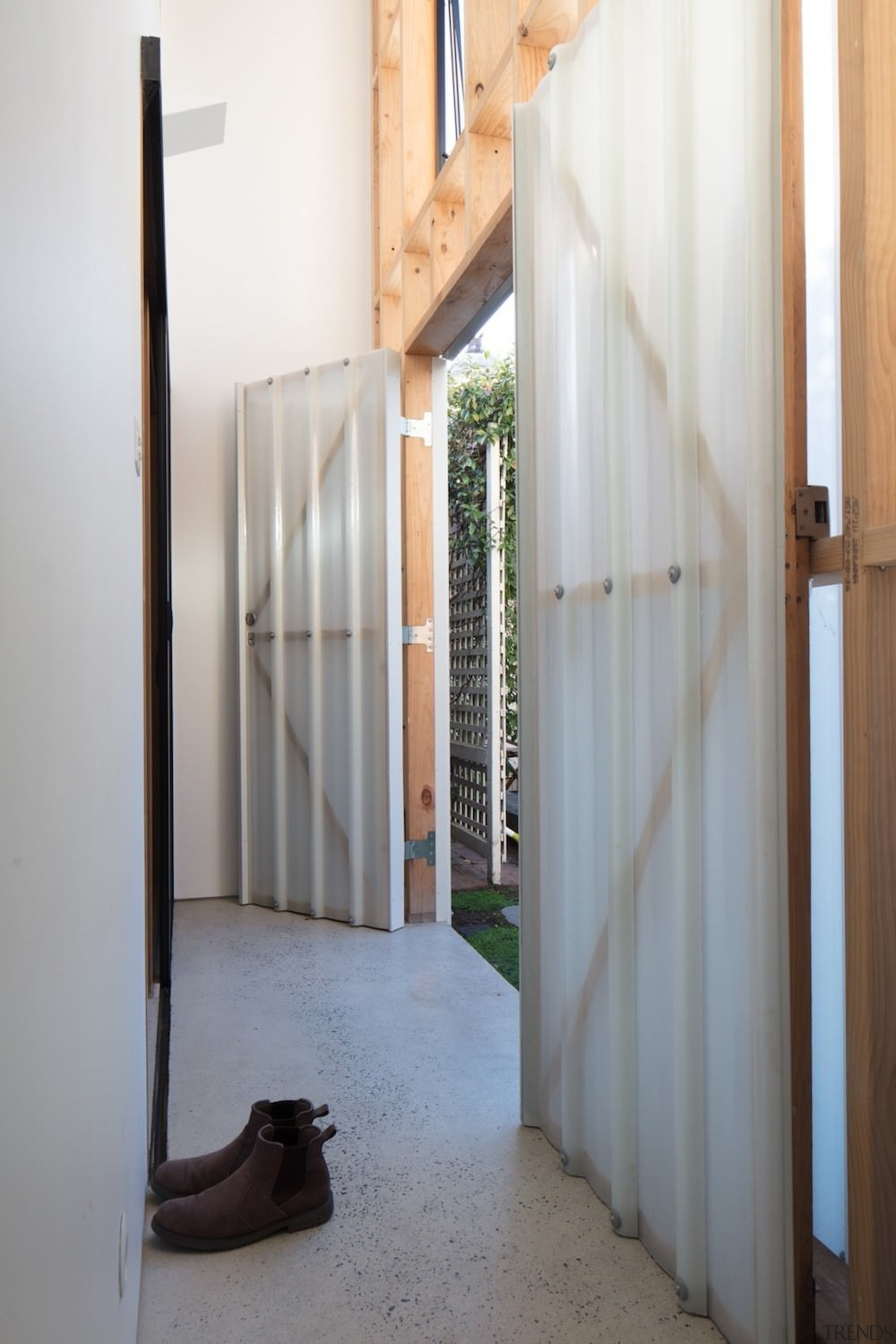 These large, barn-like doors open up to a architecture, door, floor, house, interior design, window, wood, gray, white