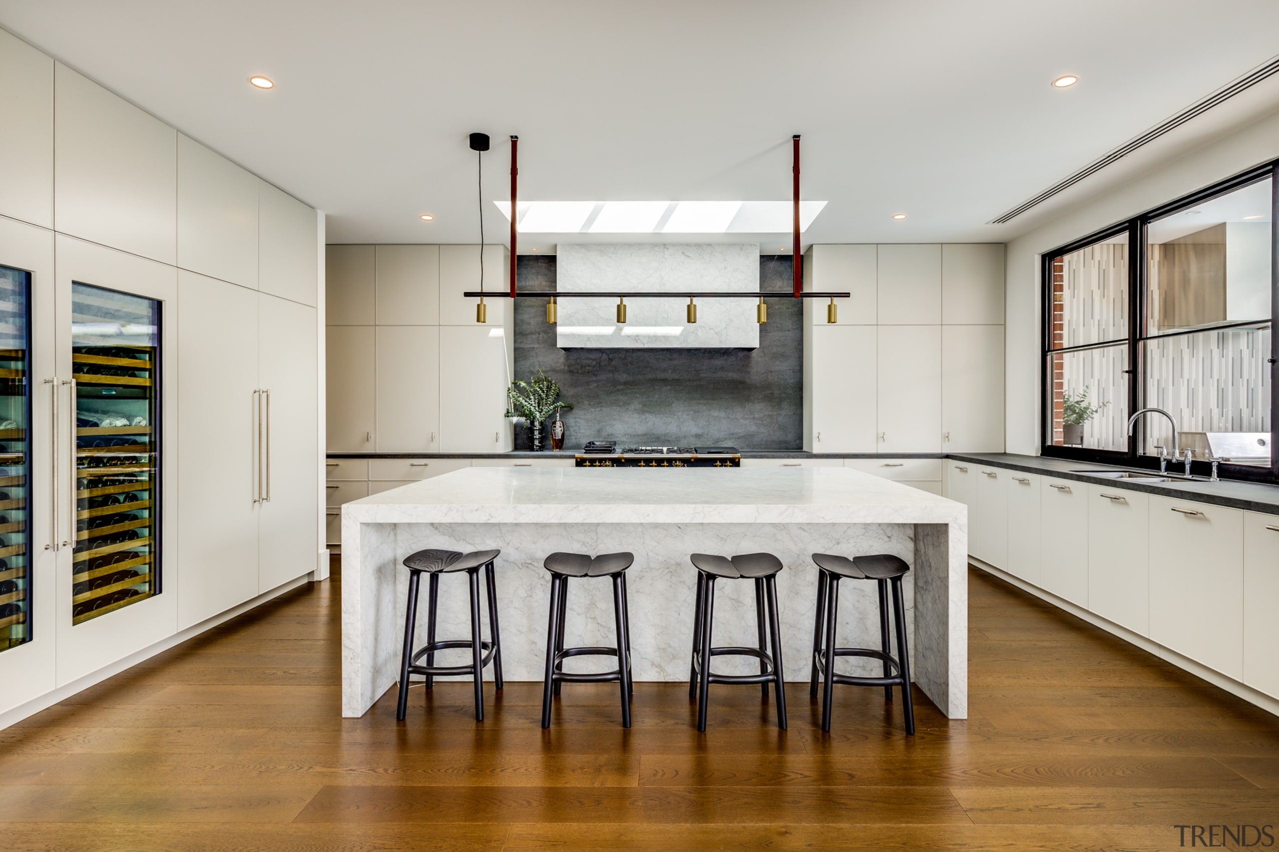 Warm wood flooring sets off the symmetrical new 