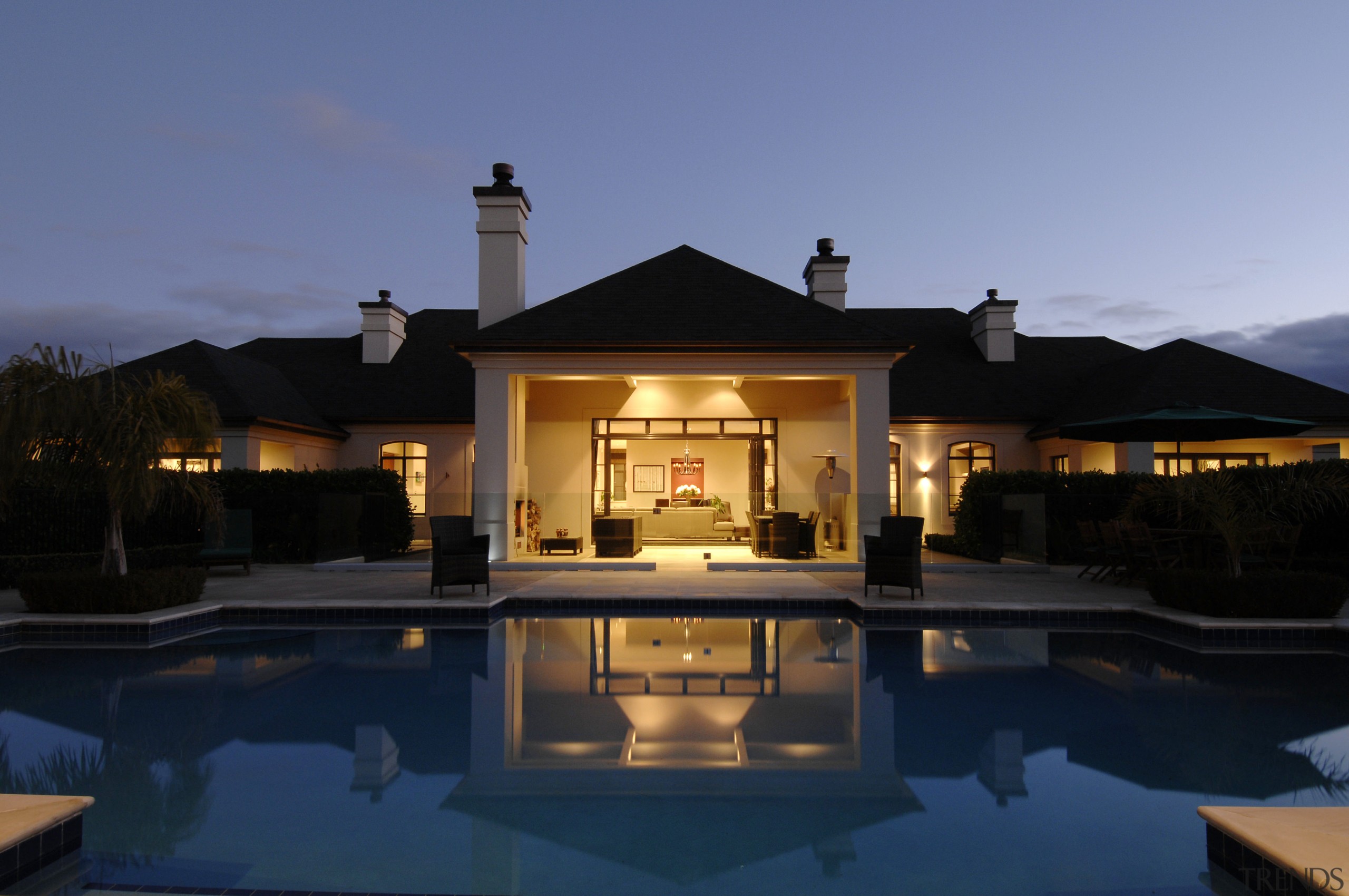 This house was designed by Mark Wilson of architecture, estate, evening, home, house, lighting, property, real estate, reflection, resort, sky, swimming pool, villa, blue, black