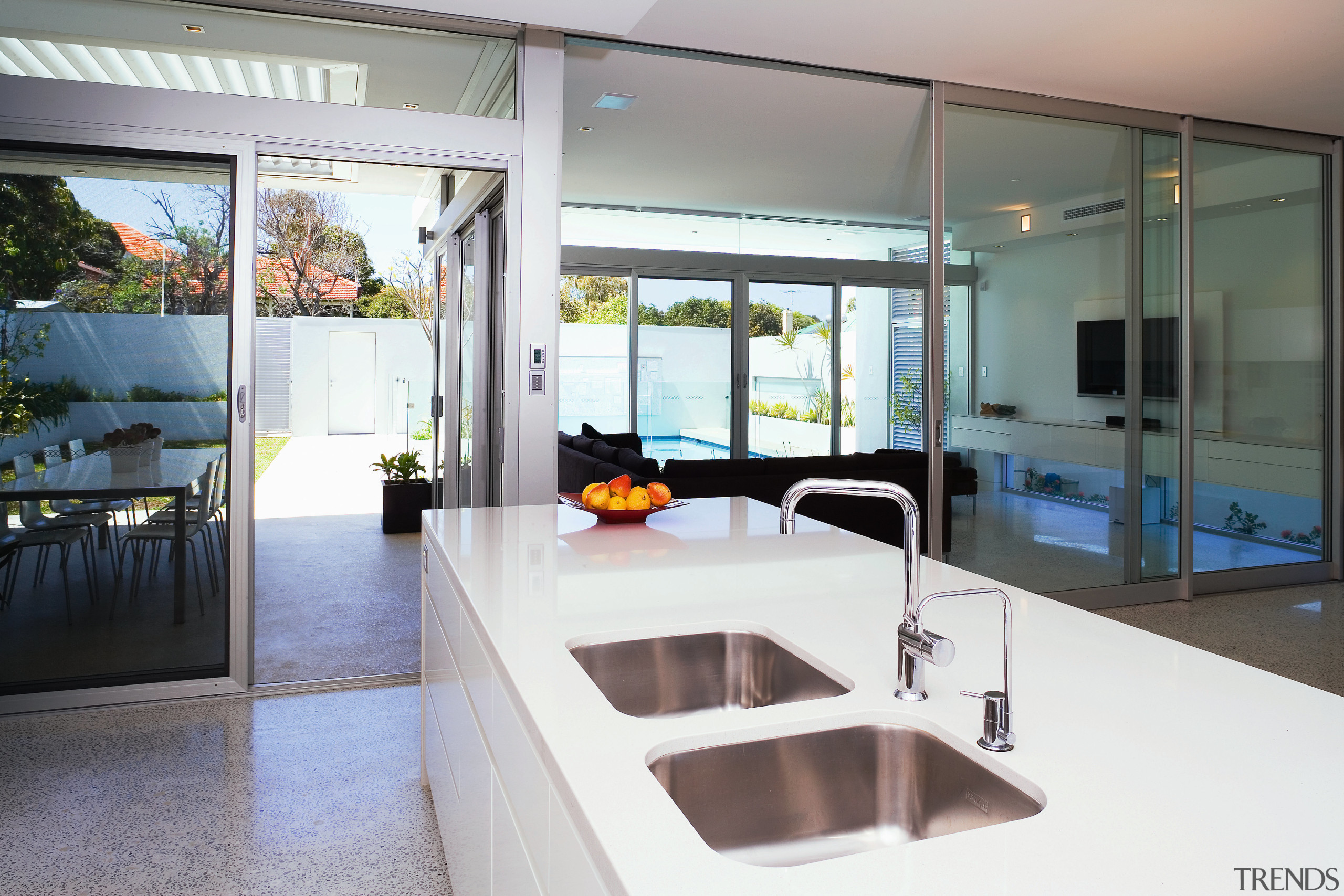 View of this kitchen featuring polished concrete flooring, countertop, house, interior design, kitchen, real estate, window, gray, white