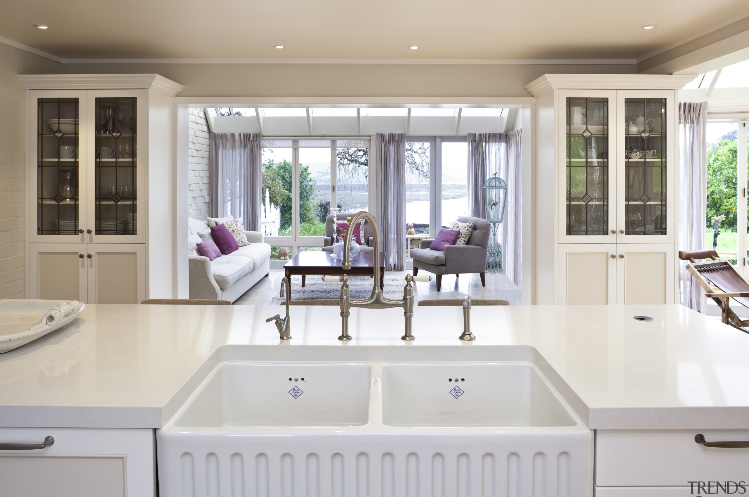 View of a traditional-styled kitchen which features a countertop, estate, home, interior design, kitchen, real estate, room, sink, window, gray, white