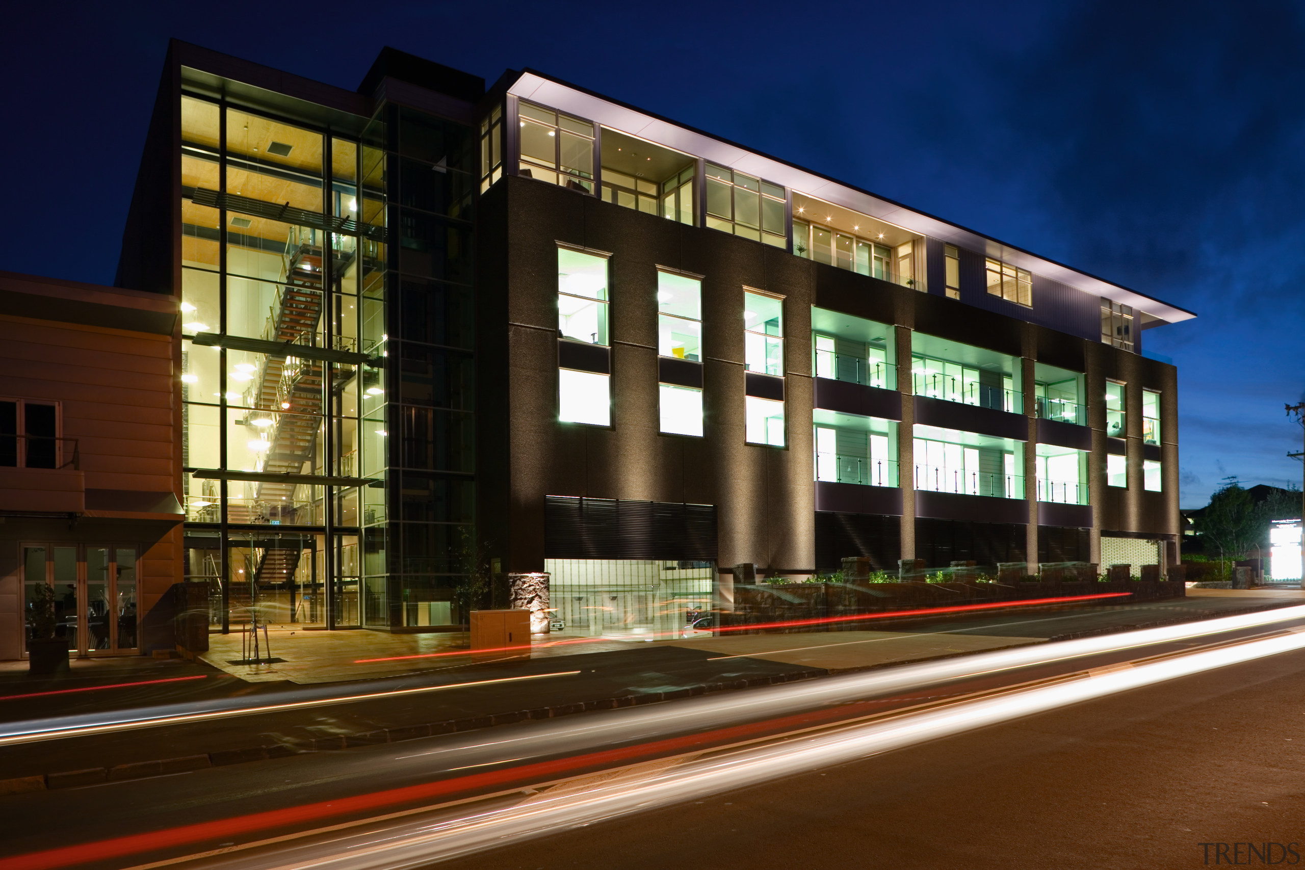 A view of the Trends Building. - A apartment, architecture, building, city, commercial building, condominium, corporate headquarters, evening, facade, headquarters, home, house, metropolis, metropolitan area, mixed use, neighbourhood, night, real estate, residential area, sky, window, brown