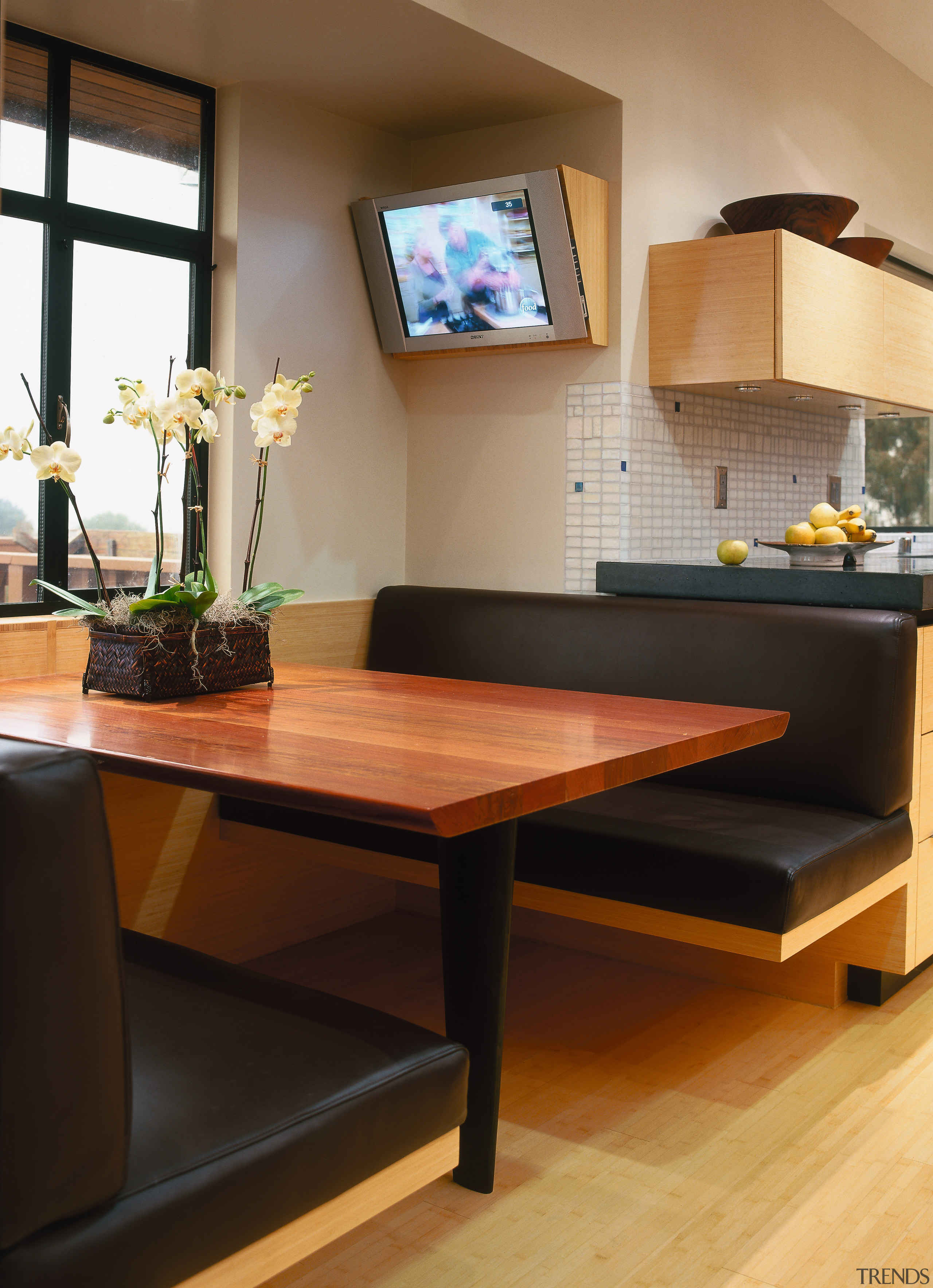 A view of the banquette in the kictehn, coffee table, desk, floor, flooring, furniture, hardwood, interior design, living room, room, table, black, brown