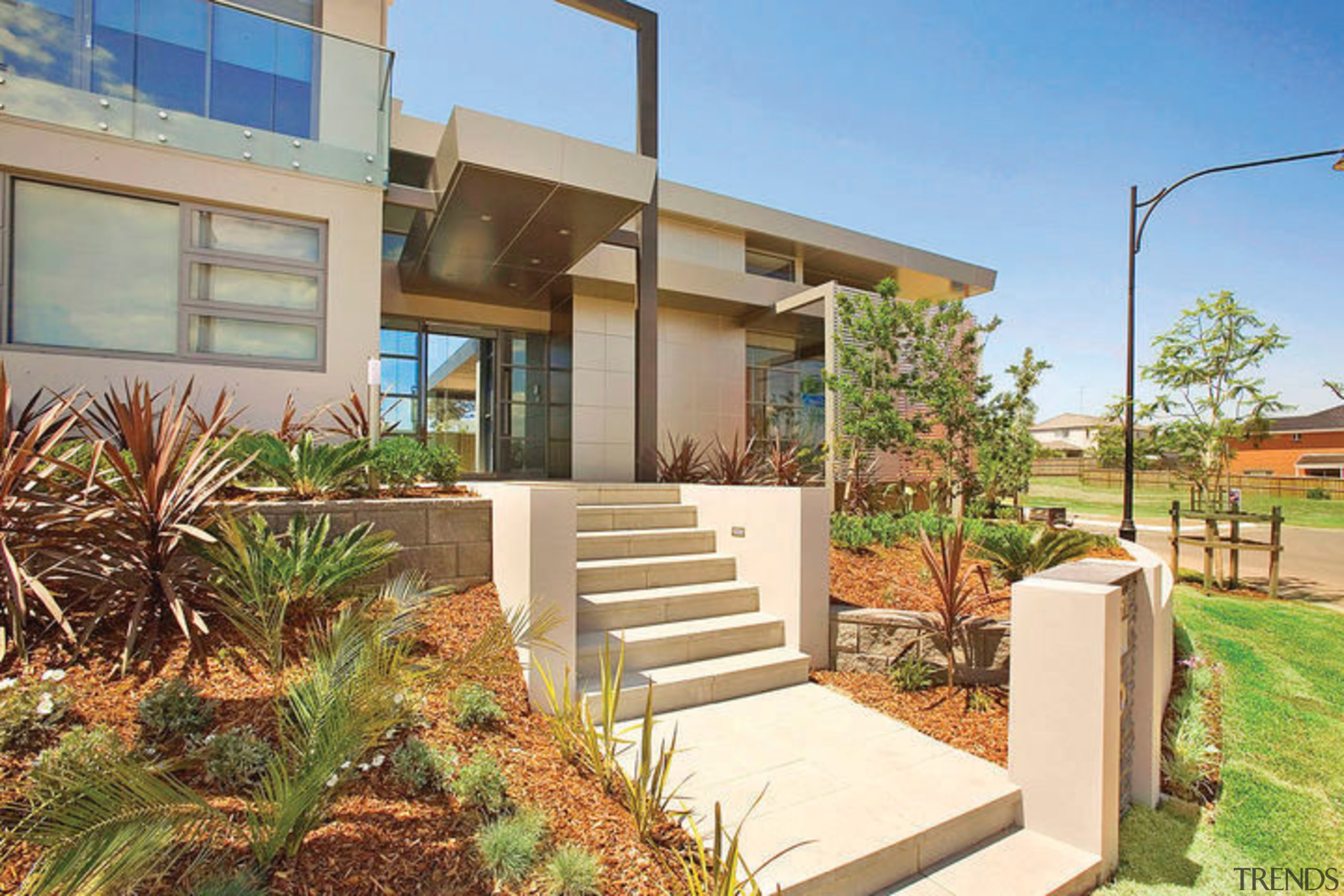 Exterior view of a contemporary home designed by apartment, architecture, backyard, elevation, estate, facade, home, house, neighbourhood, property, real estate, residential area, villa, yard, brown, orange