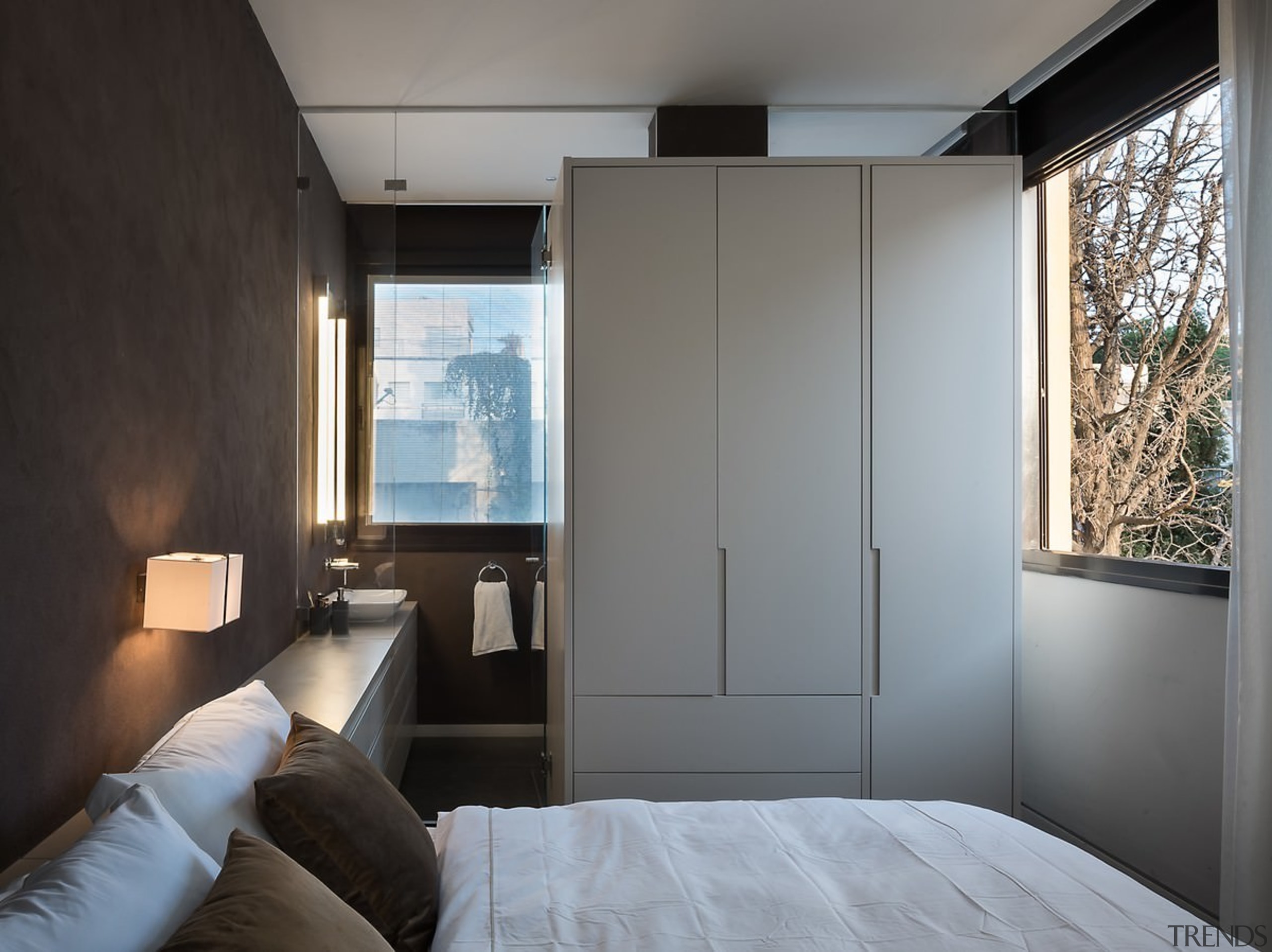 The bathroom is cleverly hidden behind this wardrobe architecture, bedroom, door, home, house, interior design, room, window, gray, black