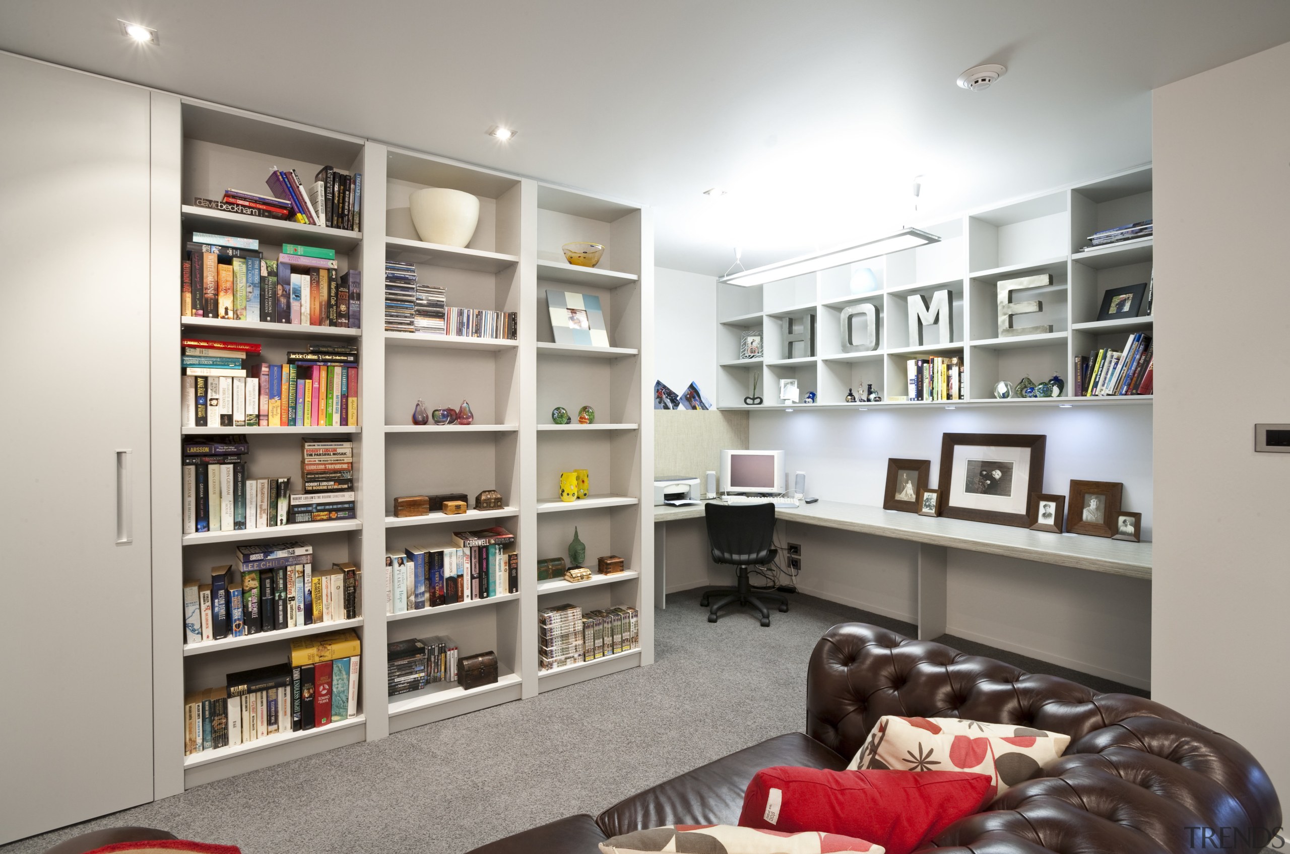 view of a living area in a home bookcase, furniture, institution, interior design, library, public library, shelf, shelving, gray