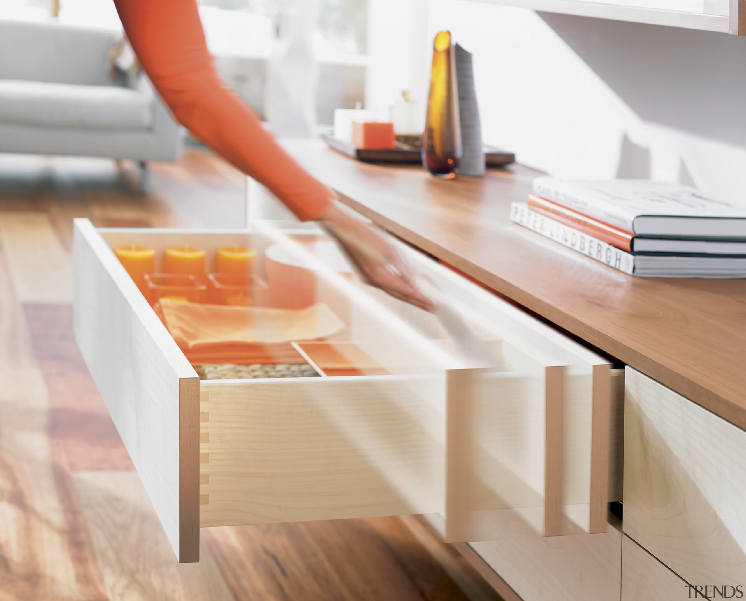 A view of a drawer system by Blum desk, drawer, floor, furniture, orange, product design, shelf, shelving, table, wood, white, orange