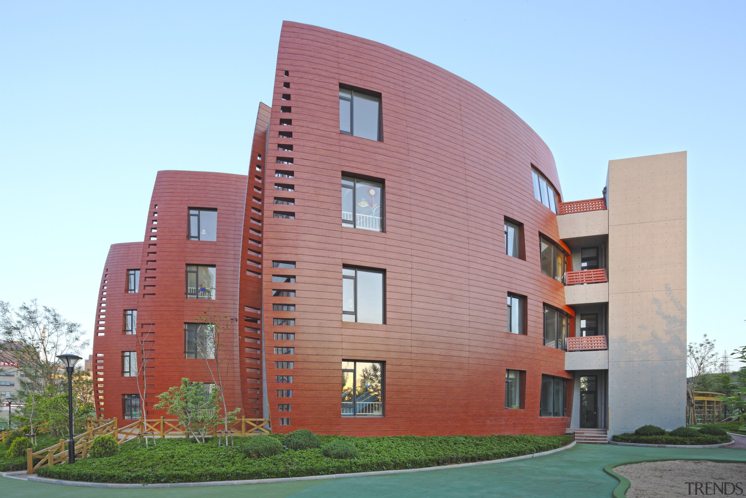 View of Dalian Preschool, with curvilinear forms and apartment, architecture, building, commercial building, condominium, corporate headquarters, elevation, estate, facade, home, house, metropolitan area, mixed use, neighbourhood, property, real estate, residential area, sky, tower block, teal, red