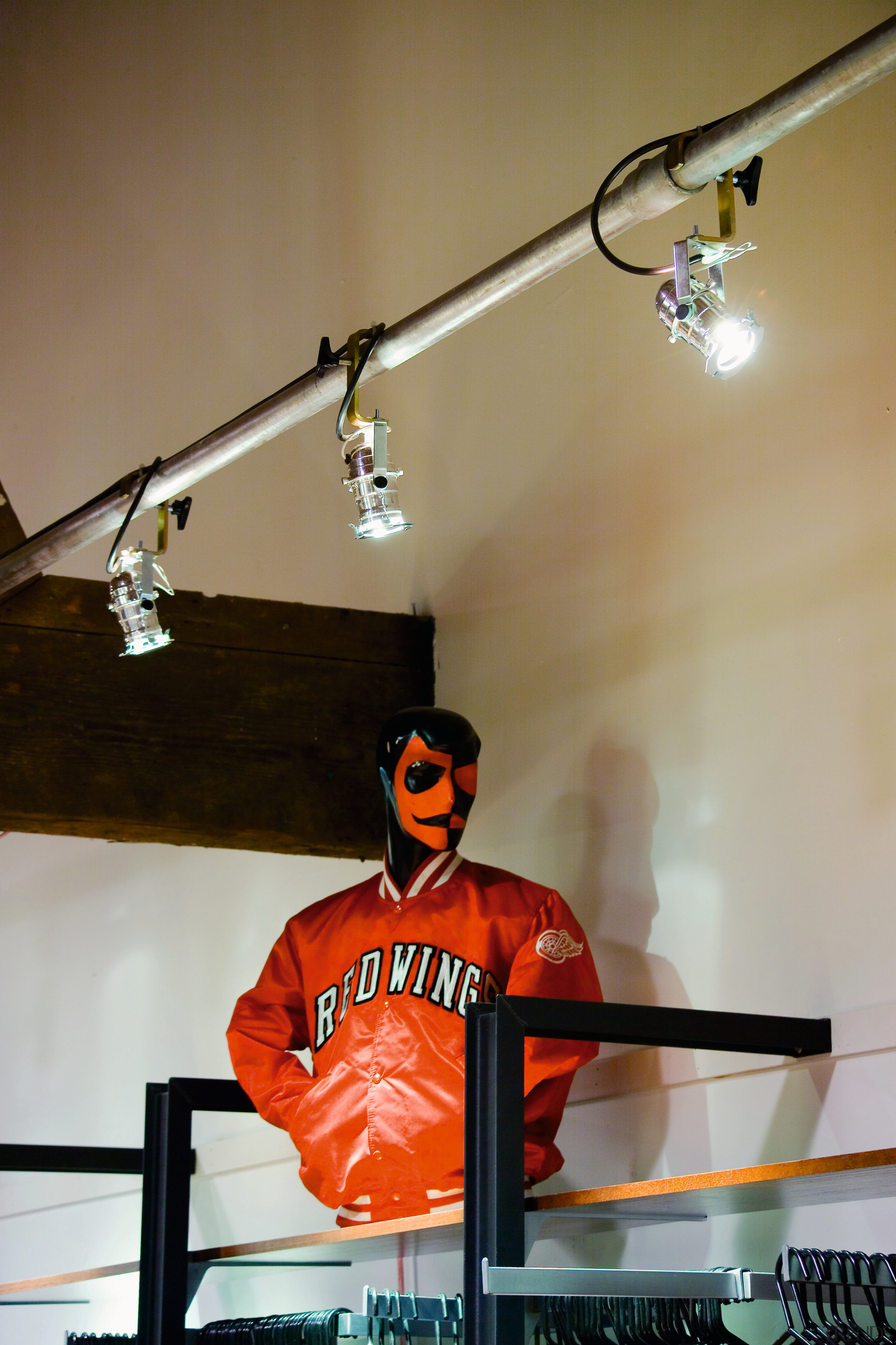 Retail shop display with spotlights on a rail. ceiling, lighting, brown