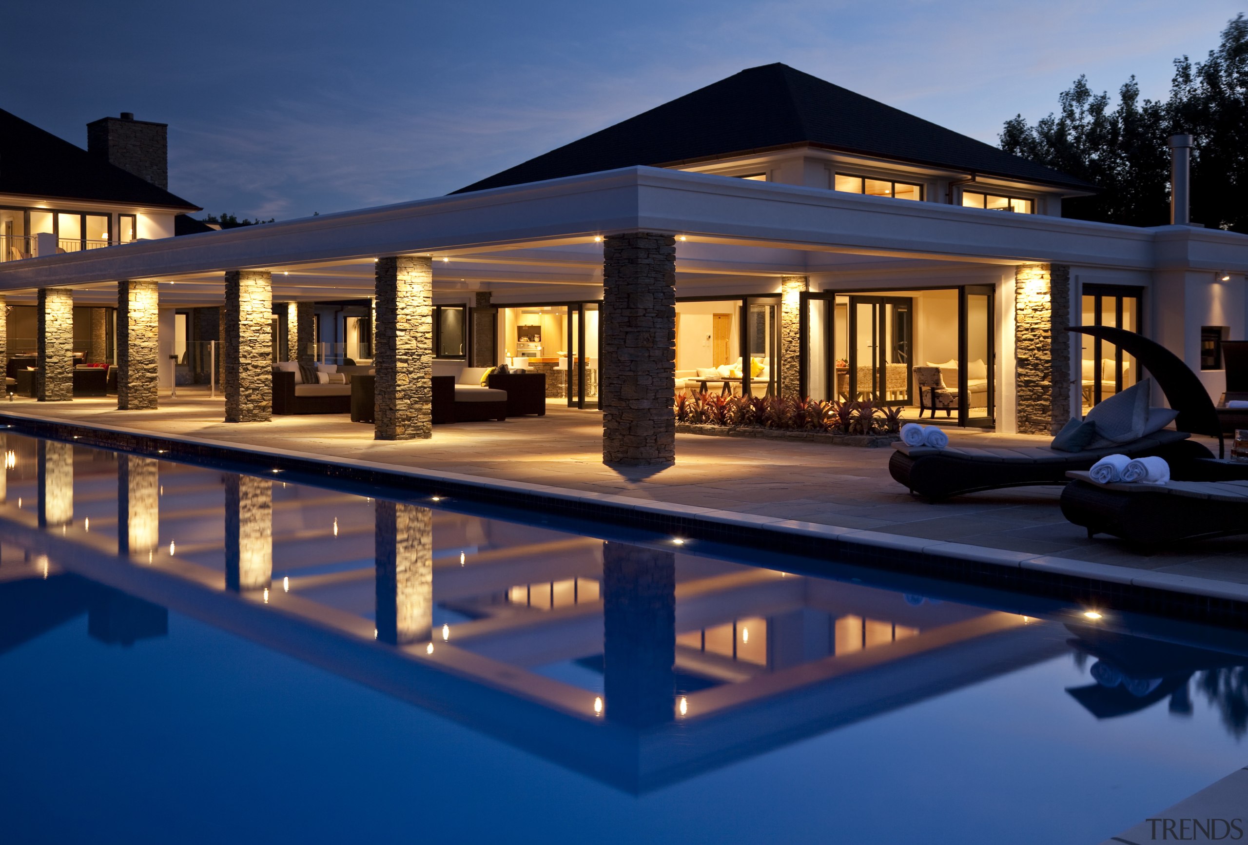 View of pool and patio area, with water apartment, architecture, estate, evening, home, hotel, house, landscape lighting, leisure, lighting, night, property, real estate, reflection, resort, sky, swimming pool, villa, water, window, blue