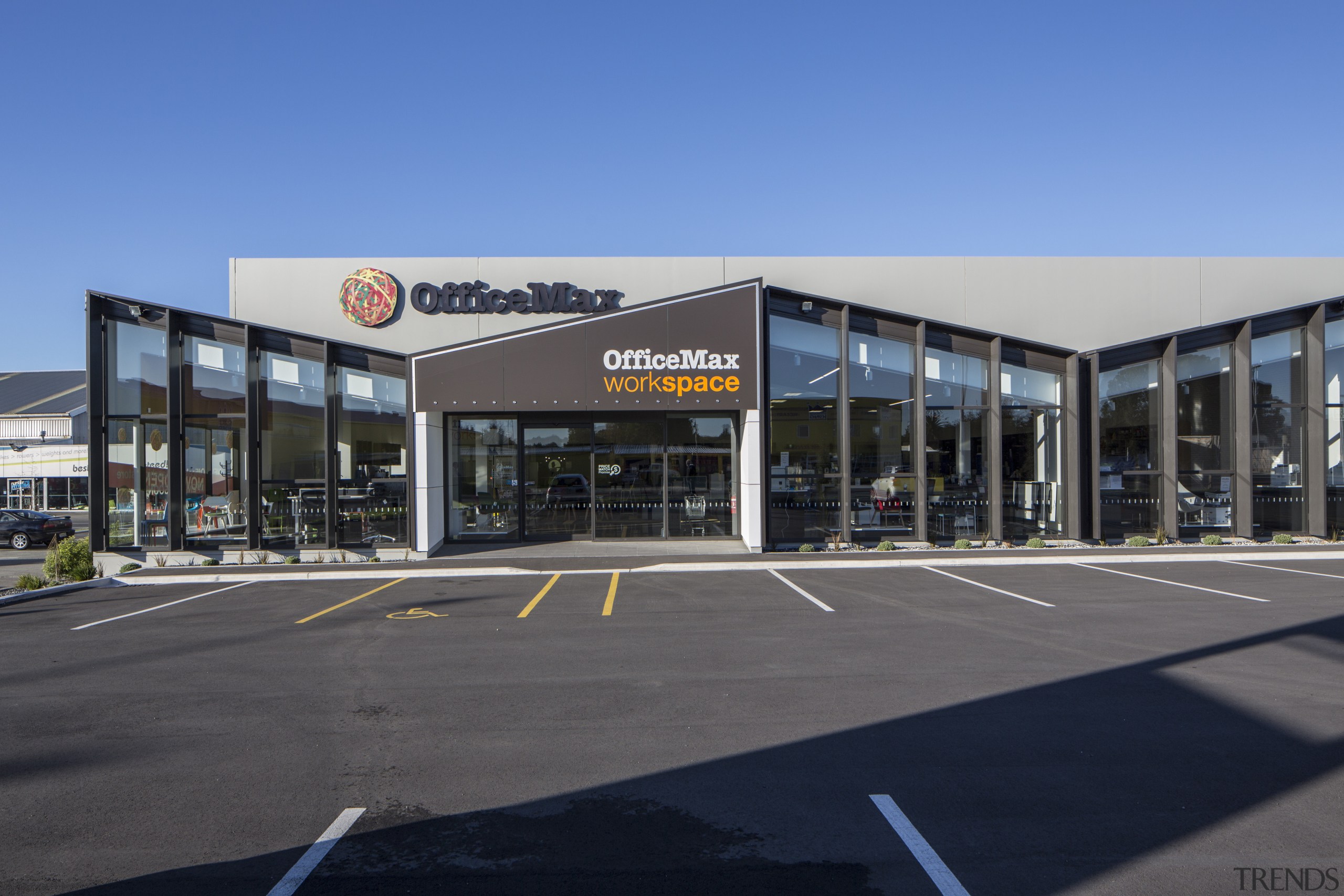 The flagship new OfficeMax workspace store in Christchurch building, car, car dealership, commercial building, corporate headquarters, mixed use, real estate, sky, teal, gray