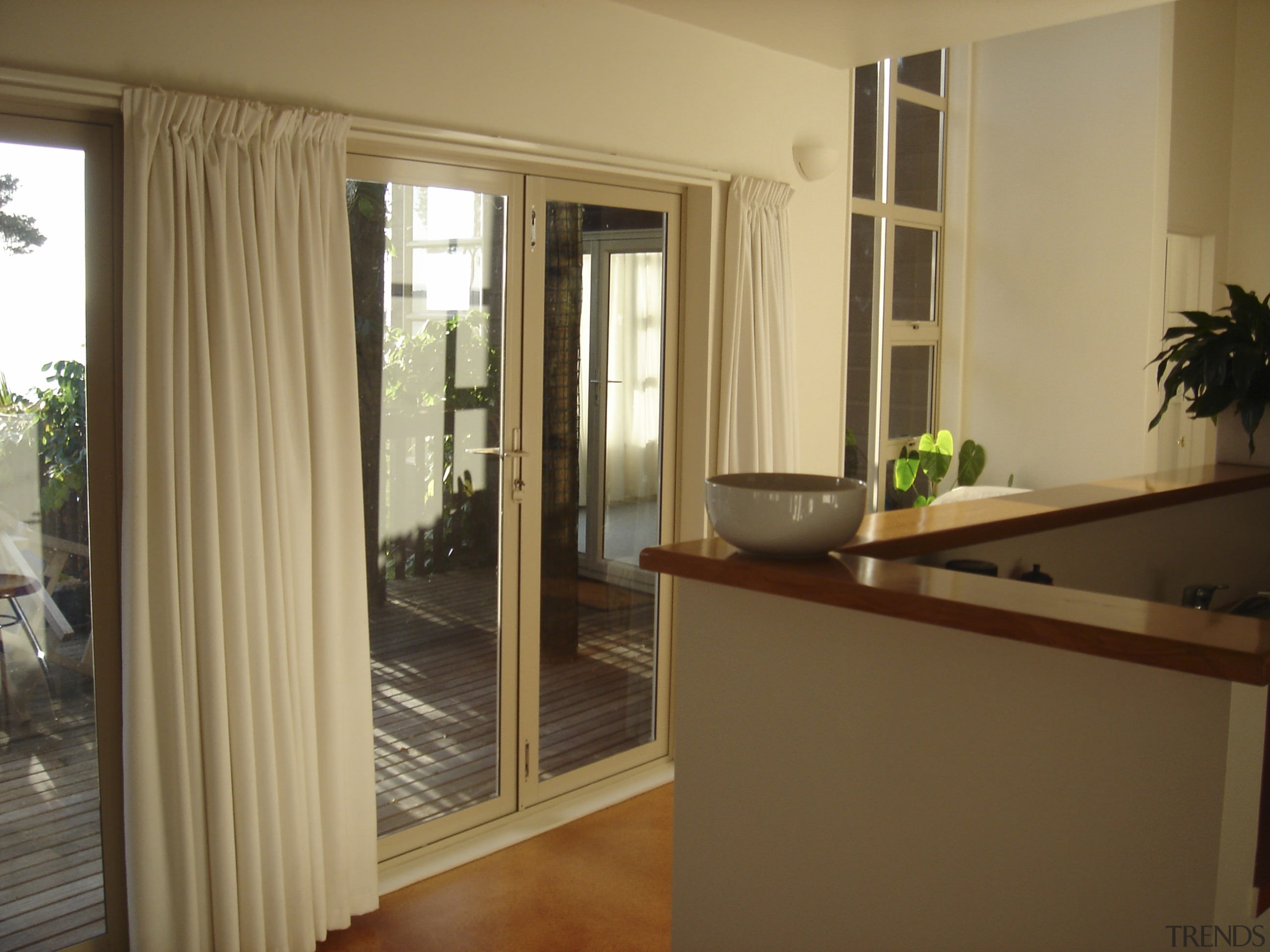 Before renovation the interior was cluttered and functioned door, floor, flooring, interior design, property, real estate, room, window, window covering, window treatment, brown, orange