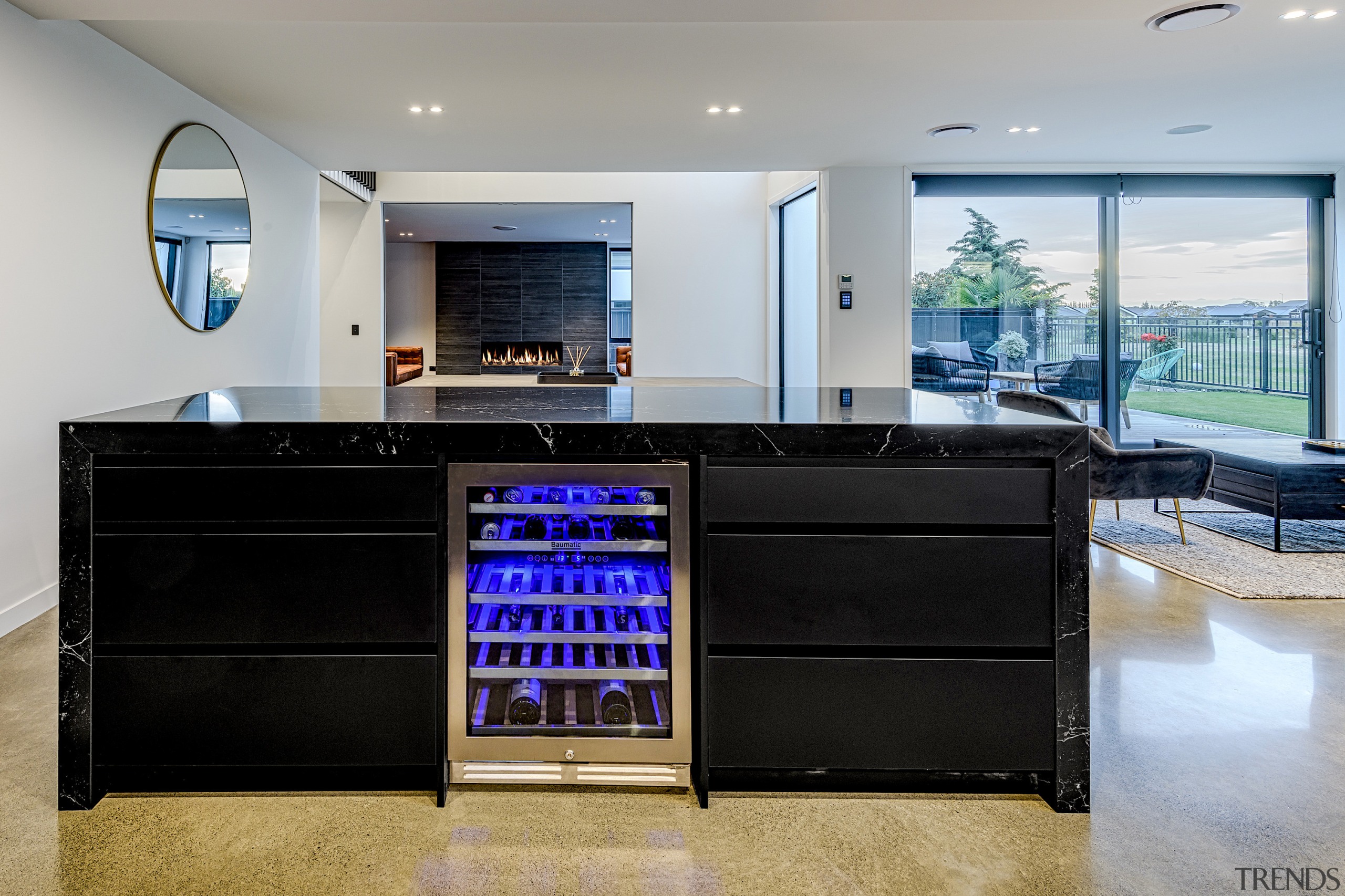 The built-in wine fridge presents as a colourful architecture, building, cabinetry, ceiling, countertop, desk, floor, flooring, furniture, home, house, interior design, kitchen, lighting, living room, property, real estate, room, table, tile, gray, black