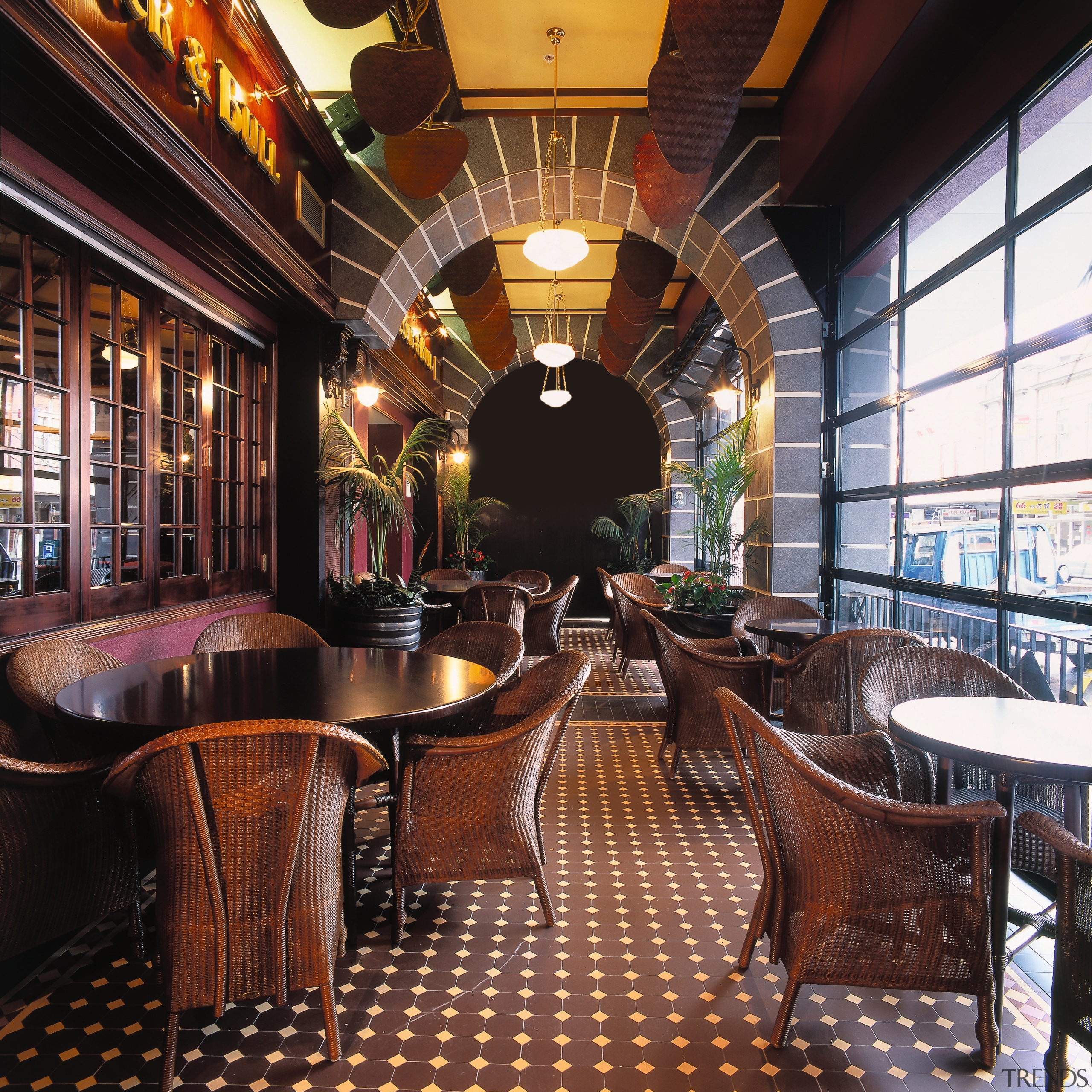 Woven armchairs around tables at restaurant, tiled flooring, café, interior design, restaurant, black