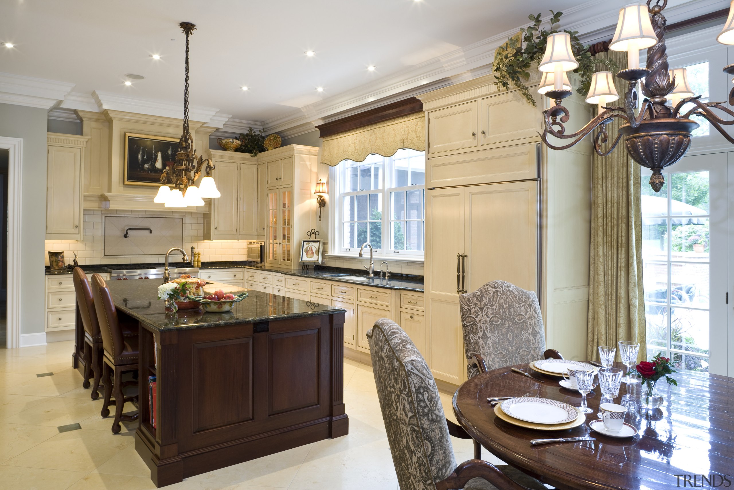 View of kitchen featuring a dark-stained mahogany island, cabinetry, countertop, cuisine classique, home, interior design, kitchen, real estate, room, window, gray