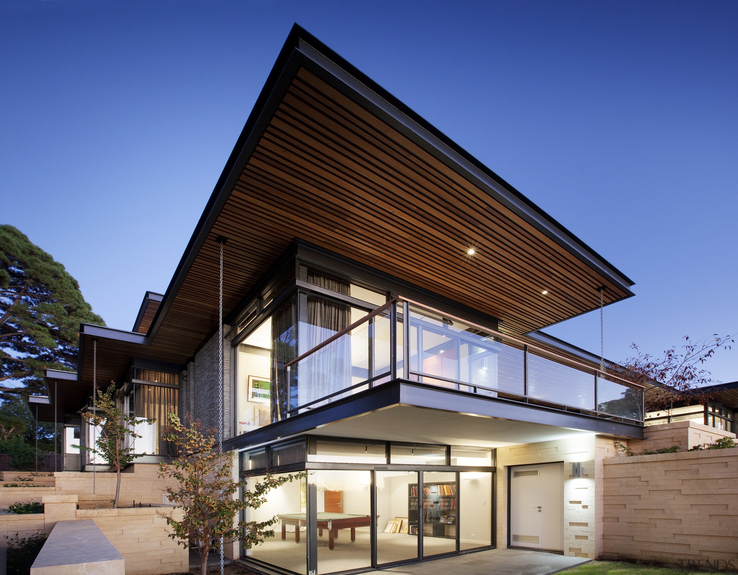 Timber-lined eaves reinforce the sleek, horizontal lines of architecture, building, commercial building, corporate headquarters, daylighting, elevation, facade, home, house, mixed use, property, real estate, residential area, roof, siding, window, blue