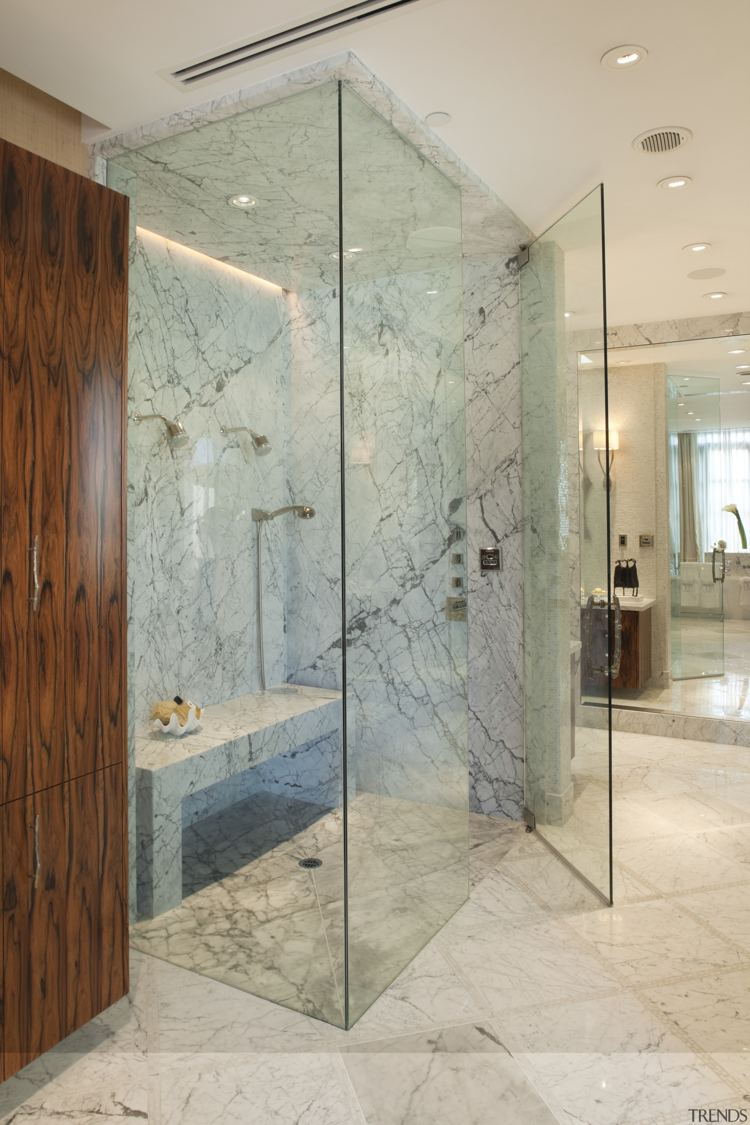 view of the shower enclosure which features marble bathroom, ceiling, floor, flooring, glass, interior design, lobby, plumbing fixture, room, shower, tile, wall, orange, gray