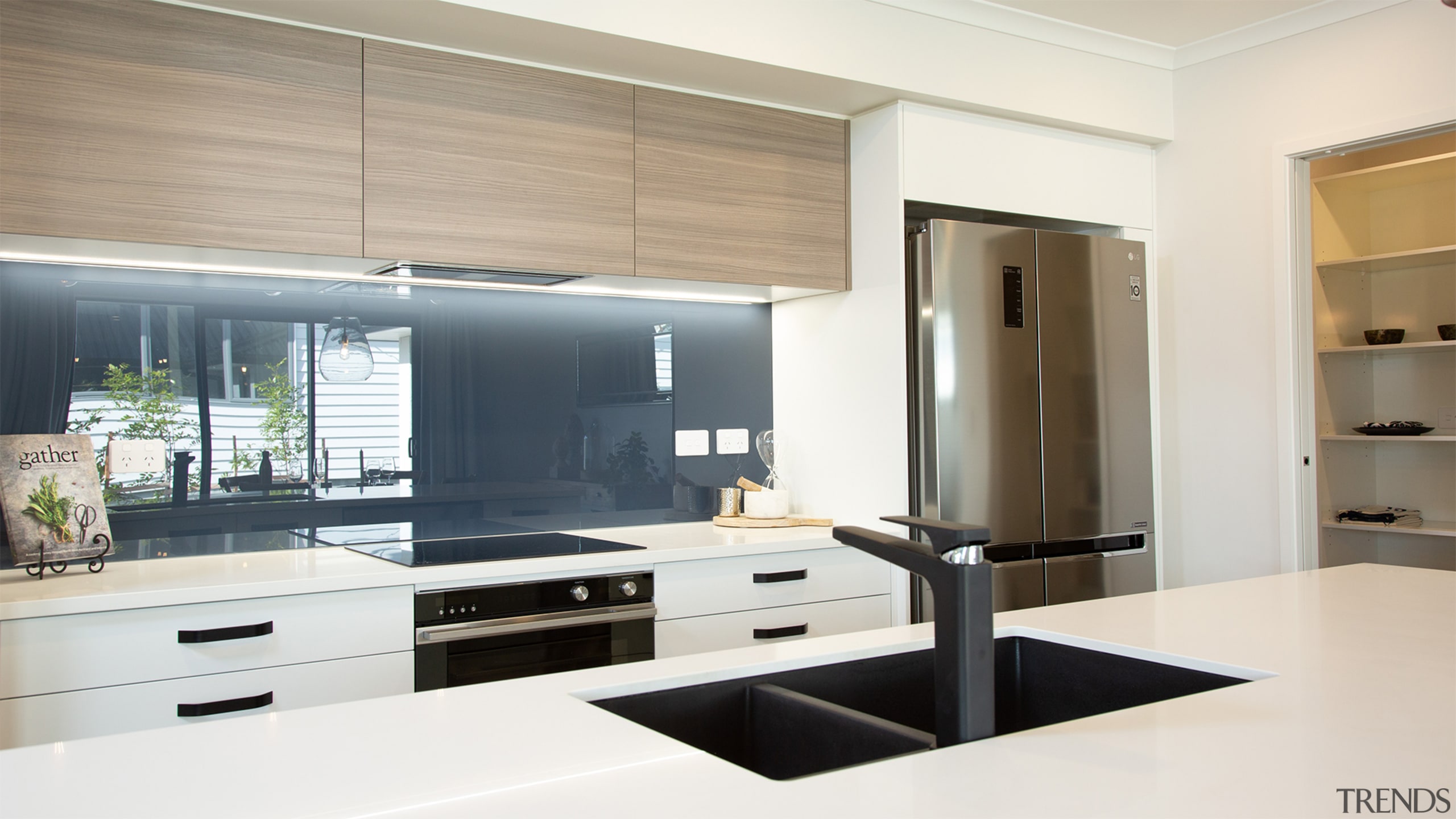 A beautiful, well-appointed kitchen with a stone benchtop 