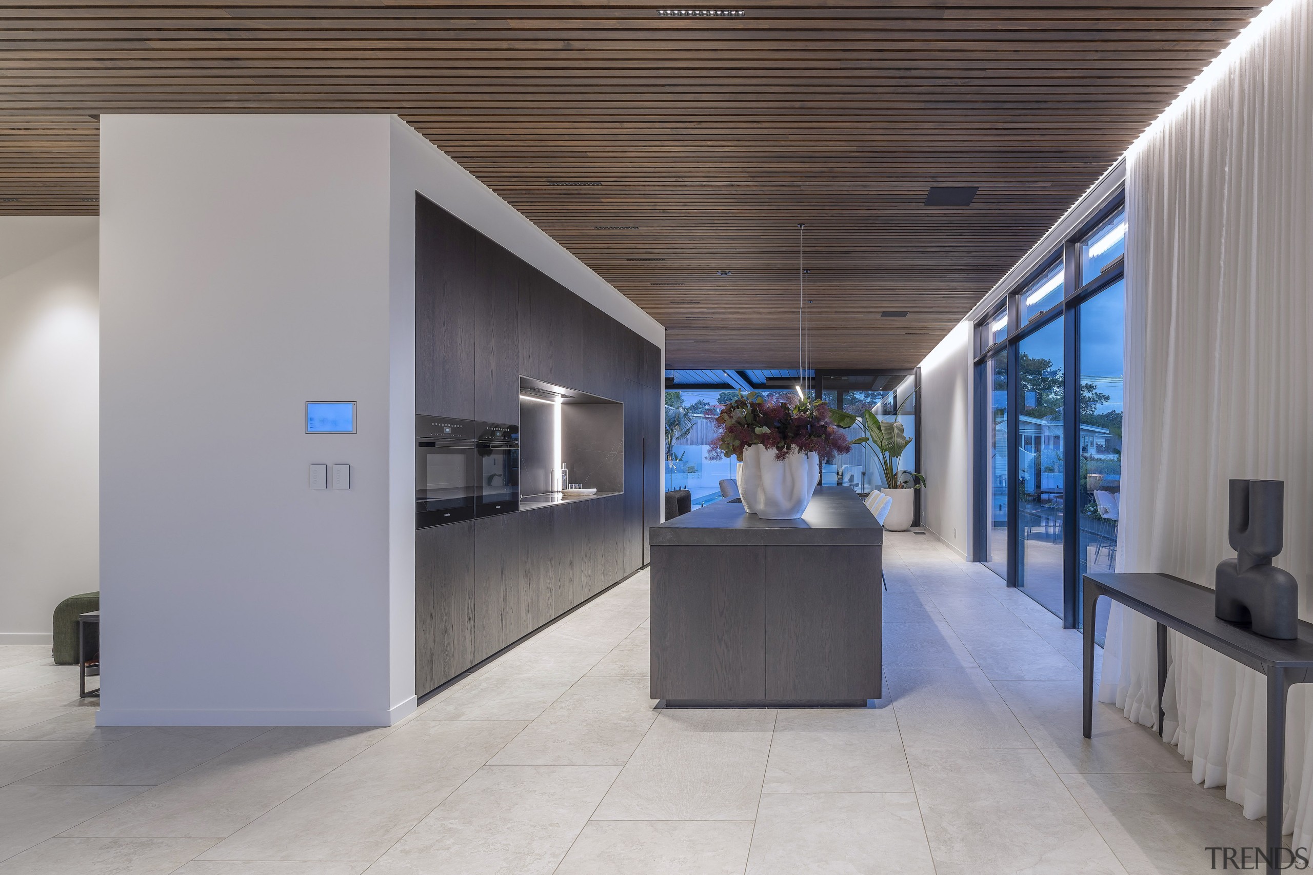 Black appliances all but disappear into the 2.7m-high 