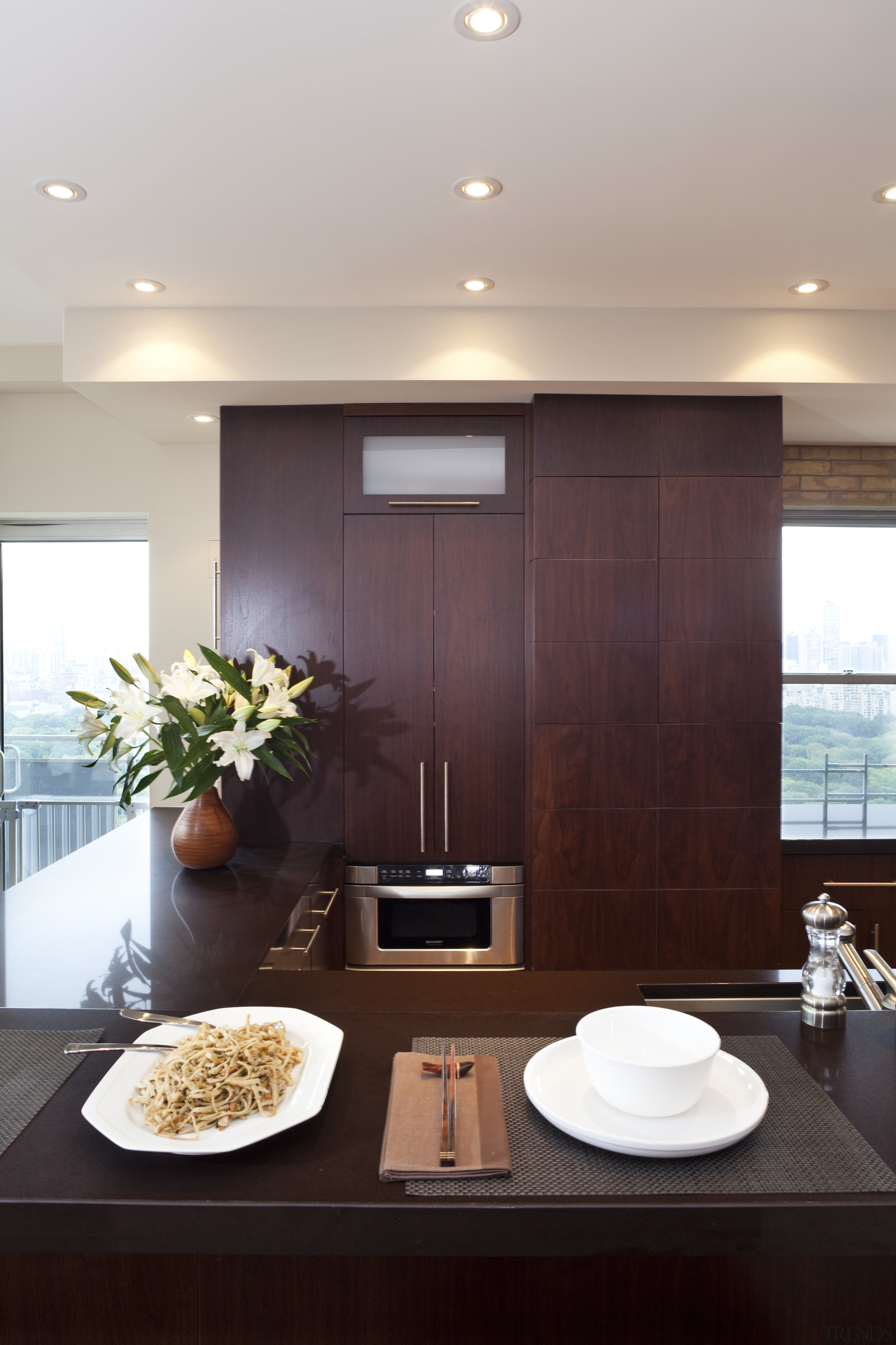 Dark wooden cabinetry, dark coloured benchtop, white walls ceiling, countertop, home, interior design, kitchen, room, table, gray, red