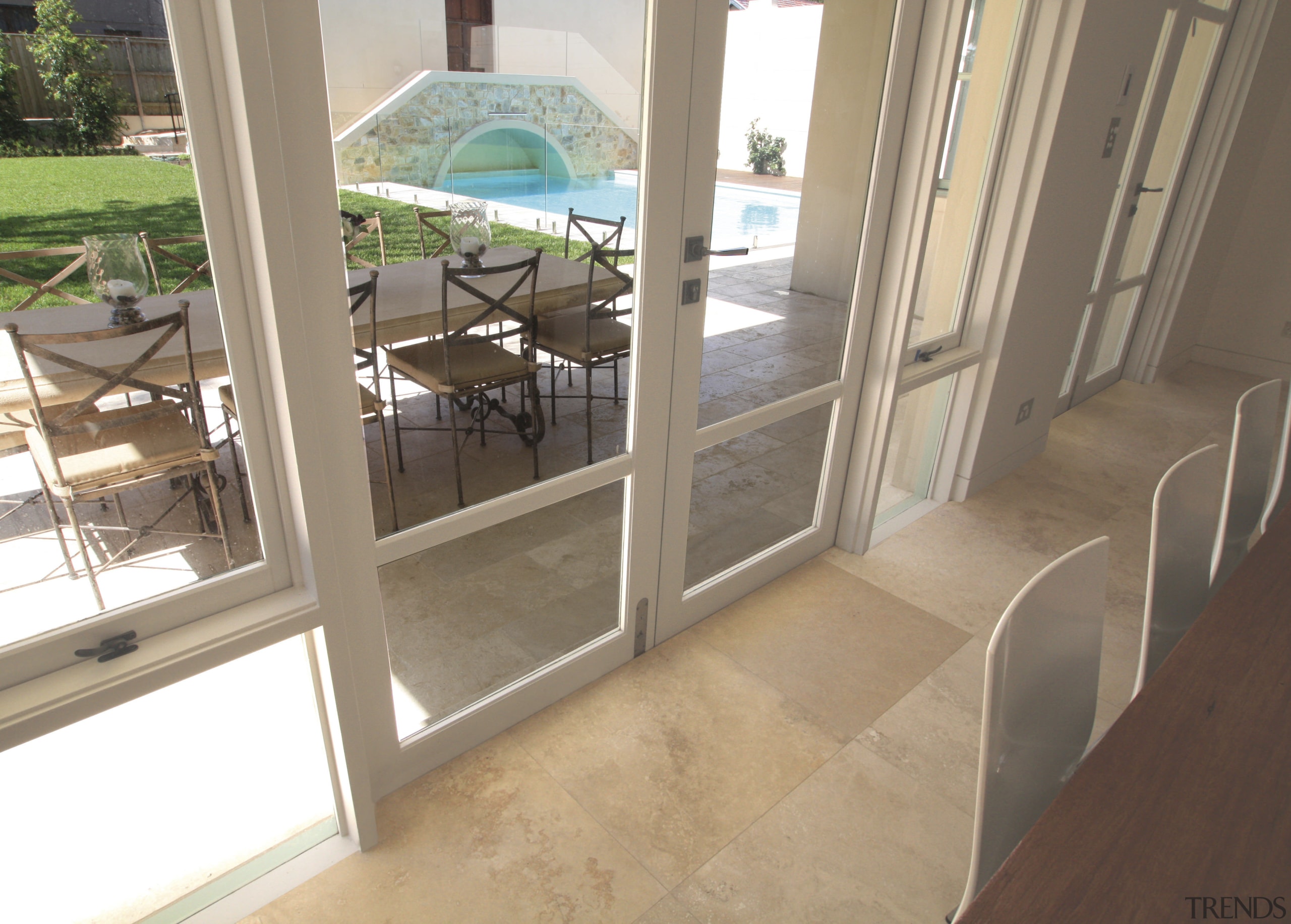 View of travertine tiled floors from SareenStone. - estate, floor, flooring, glass, handrail, home, property, real estate, tile, window, brown