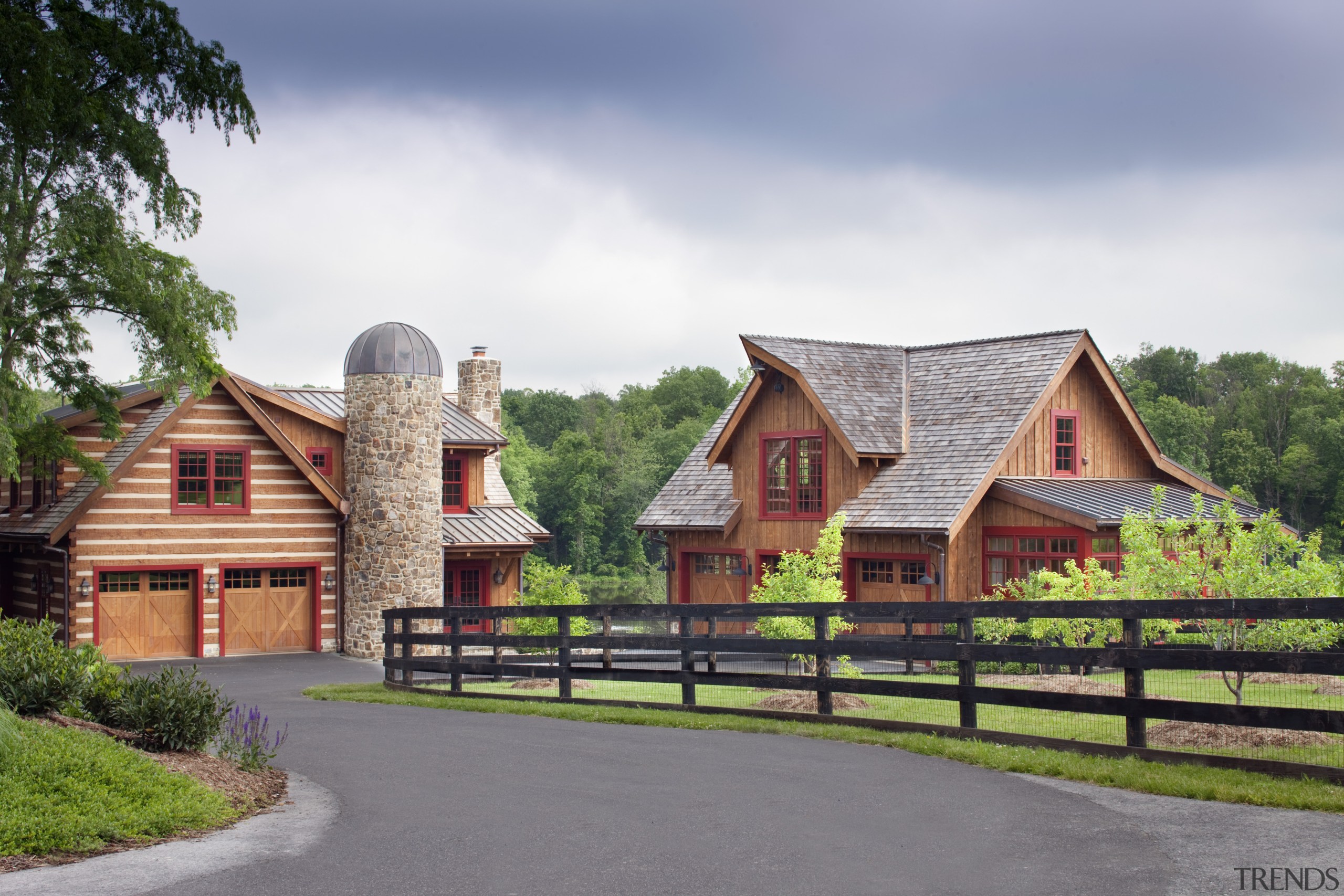 View of two wooden buildings with stone chimneys cottage, estate, farm, farmhouse, home, house, property, real estate, sky, tree, gray