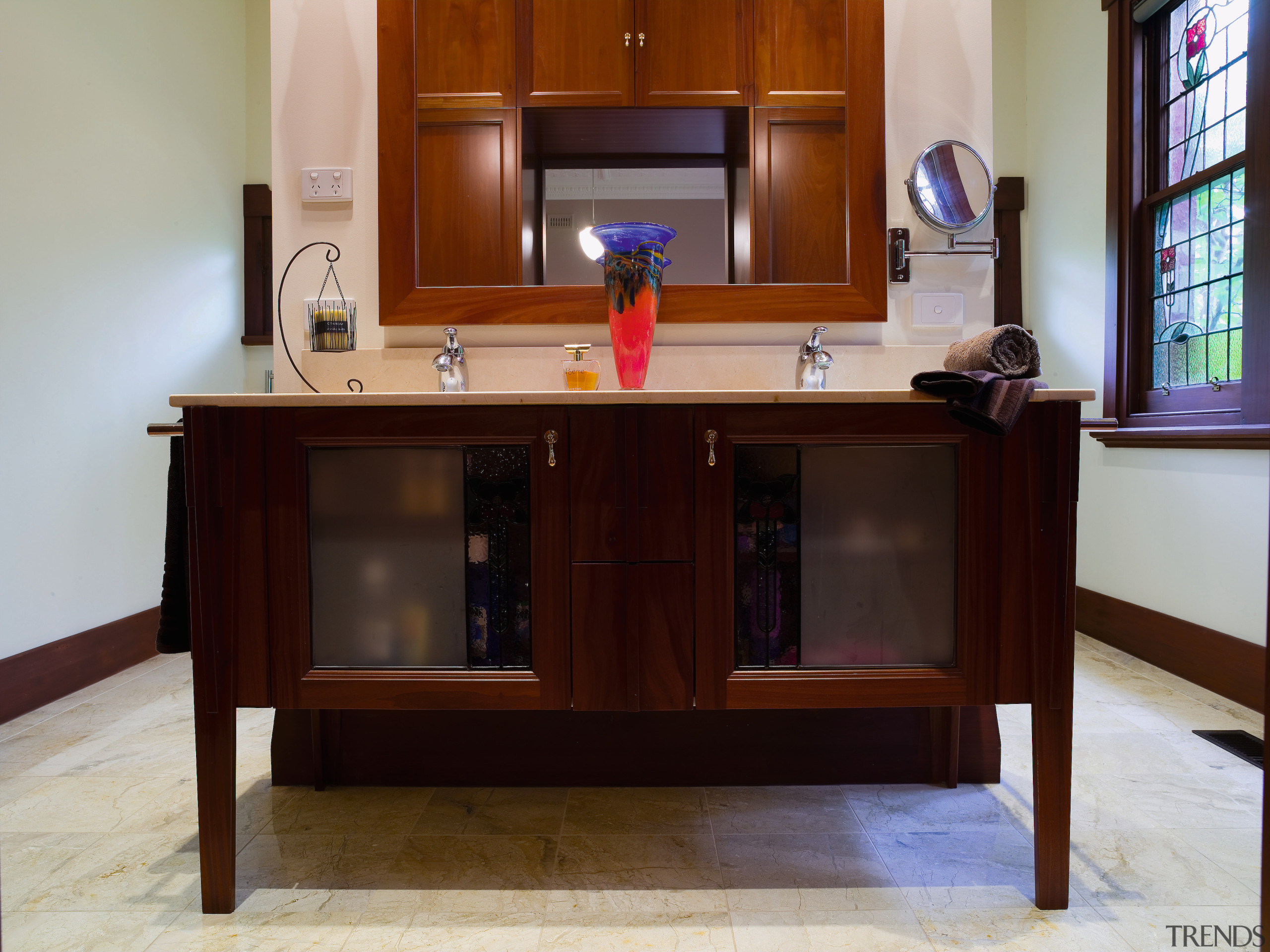 view of the bathroom featuring dante solid timber cabinetry, chest of drawers, desk, flooring, furniture, hardwood, table, wood stain, gray