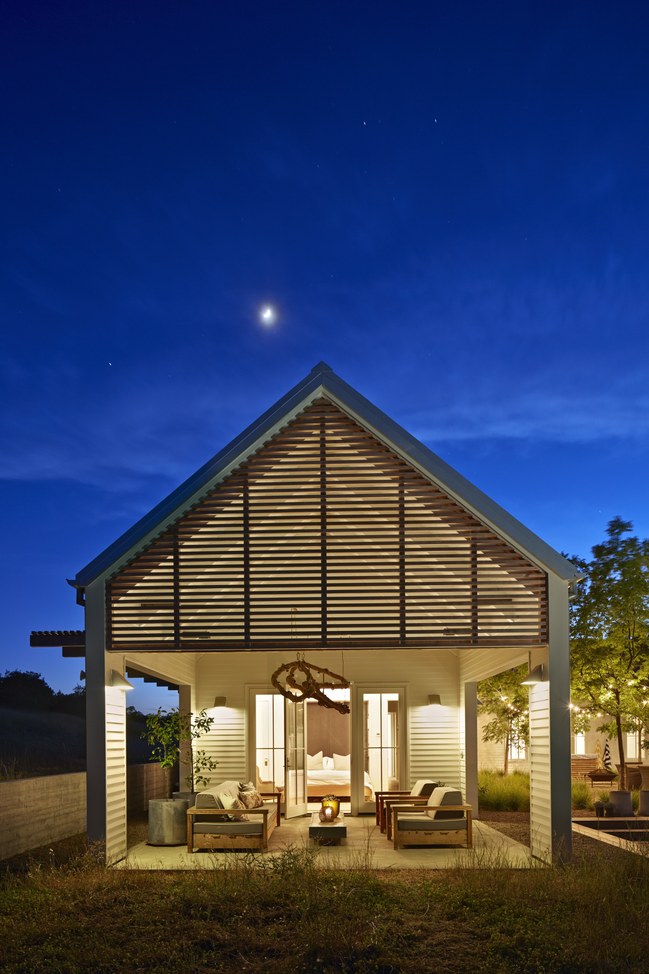 This master suite opens to a covered alfresco architecture, cottage, facade, home, house, lighting, property, real estate, residential area, sky, blue